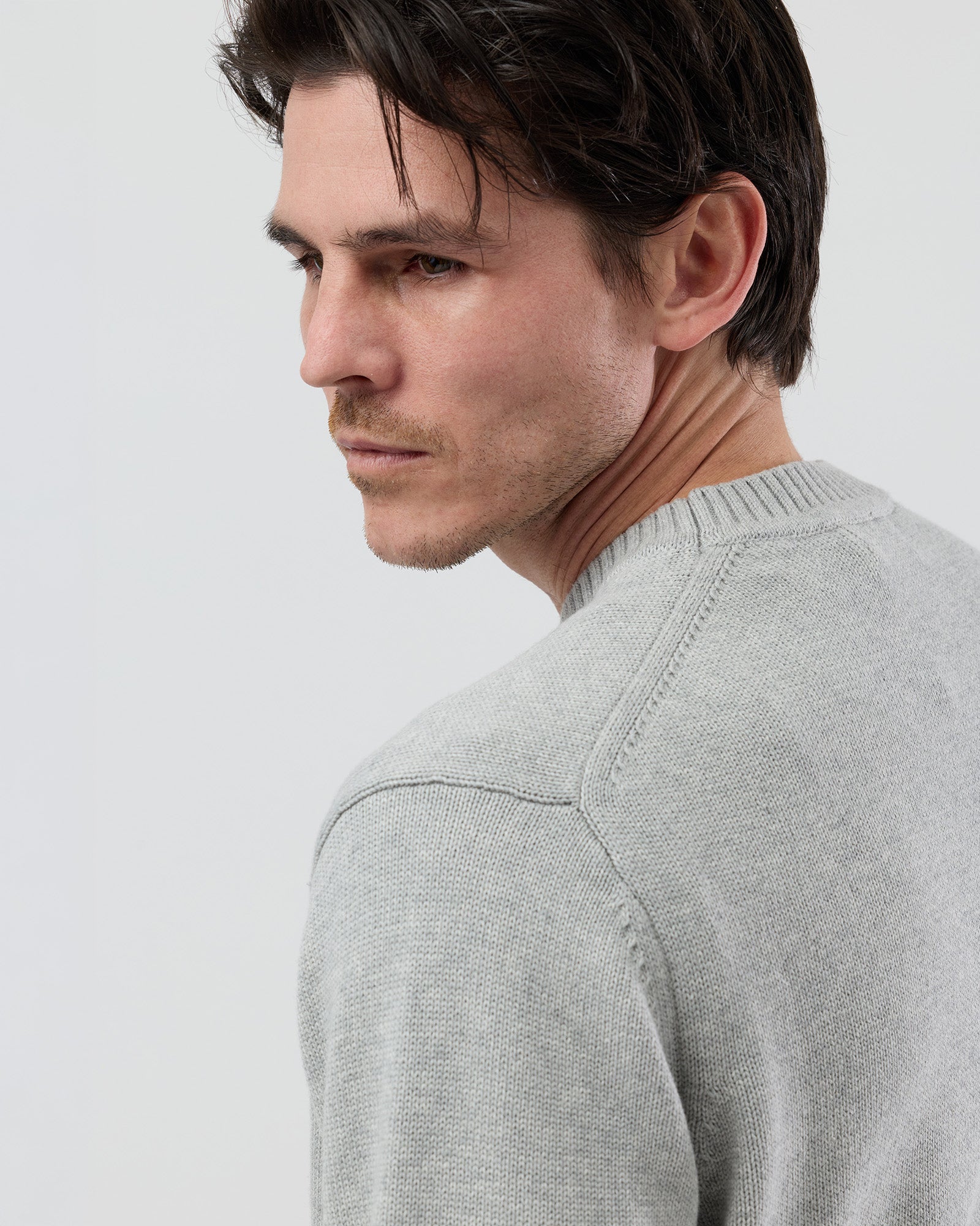 lose-up rear detail of the Wayver light grey cotton crew neck knit showing the 2x2 rib detailing around the shoulder and neckline.