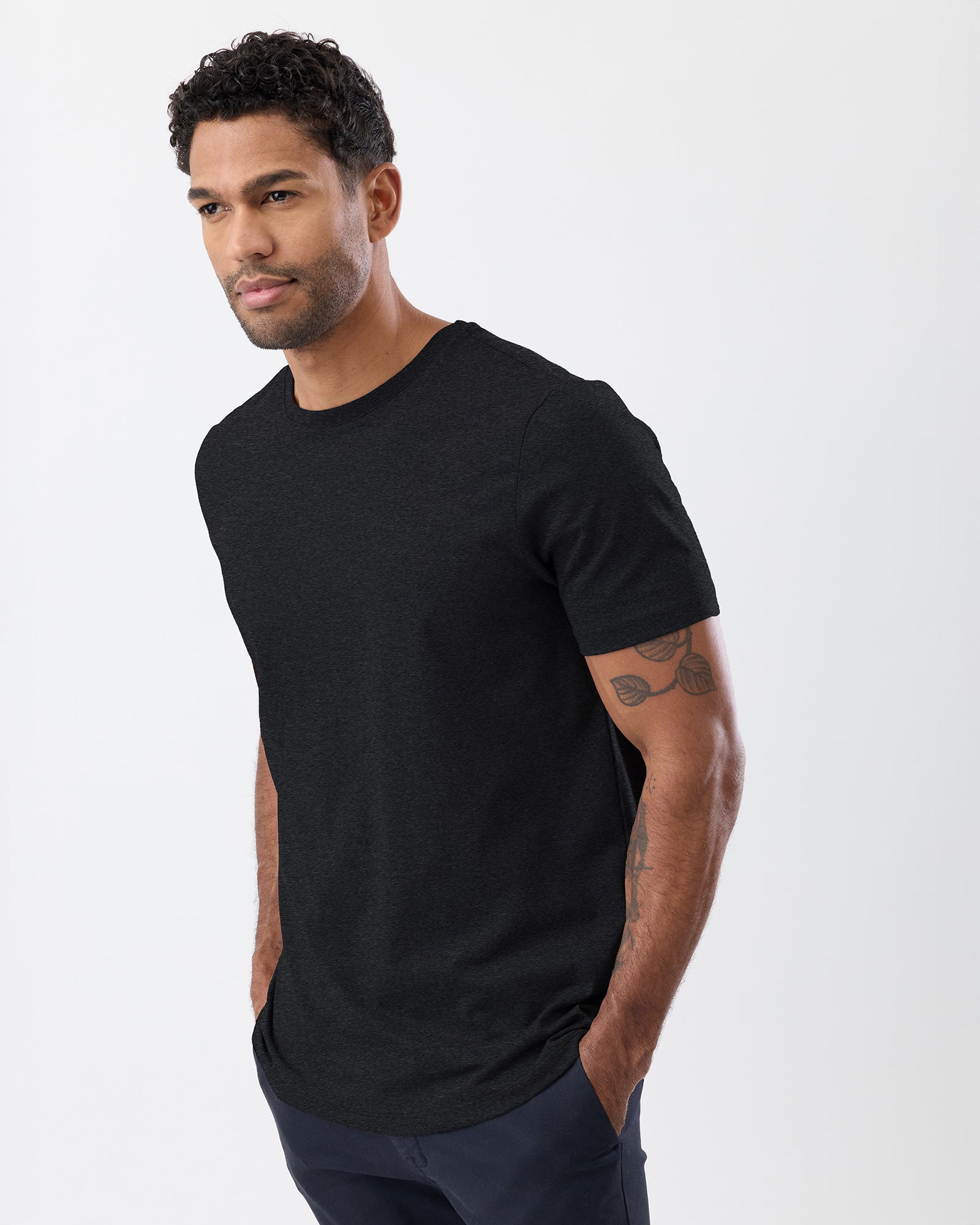 Man wearing a dark charcoal t-shirt against a white background
