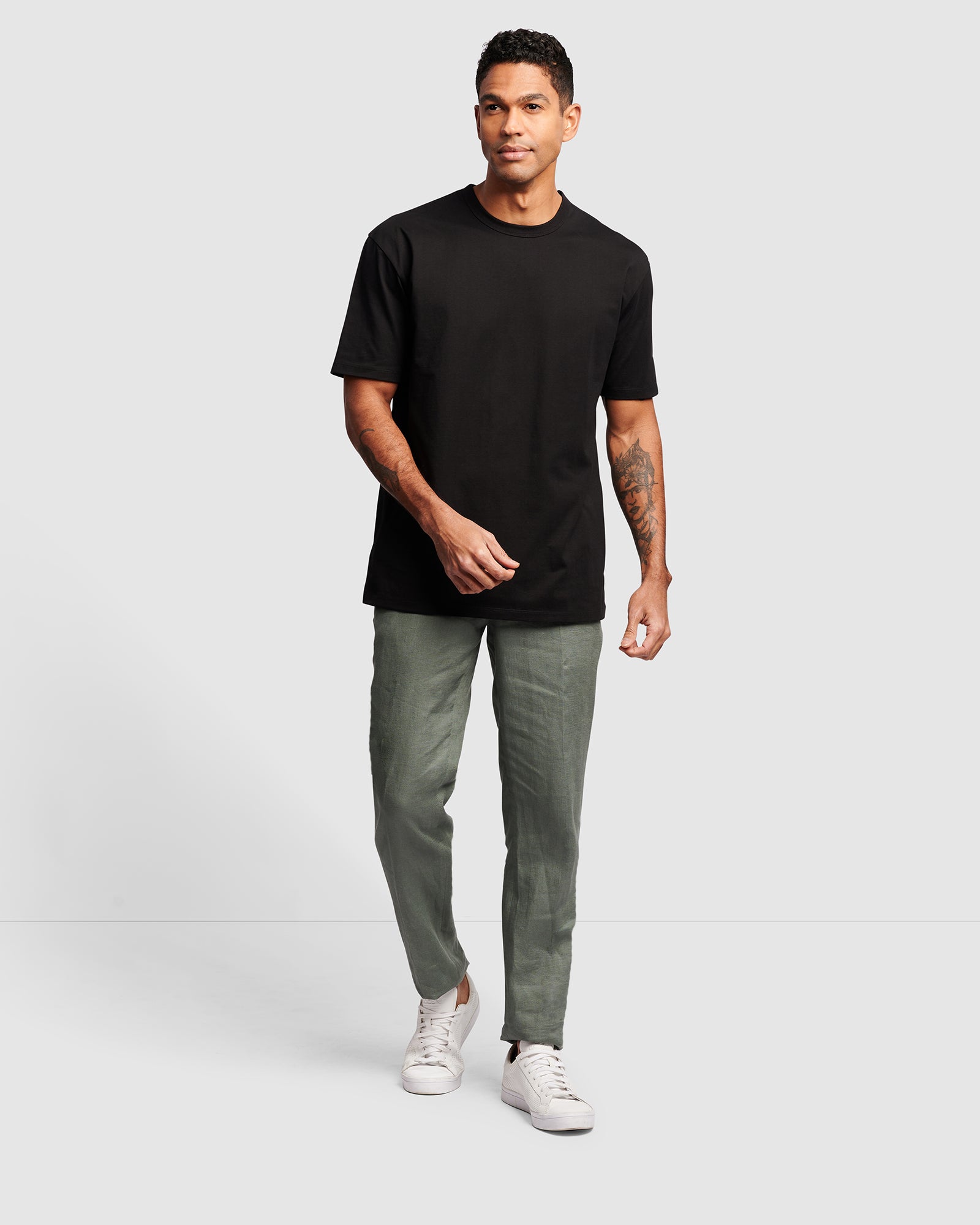 Premium Cotton Men's Black Oversized T-Shirt, worn with green chino pants
