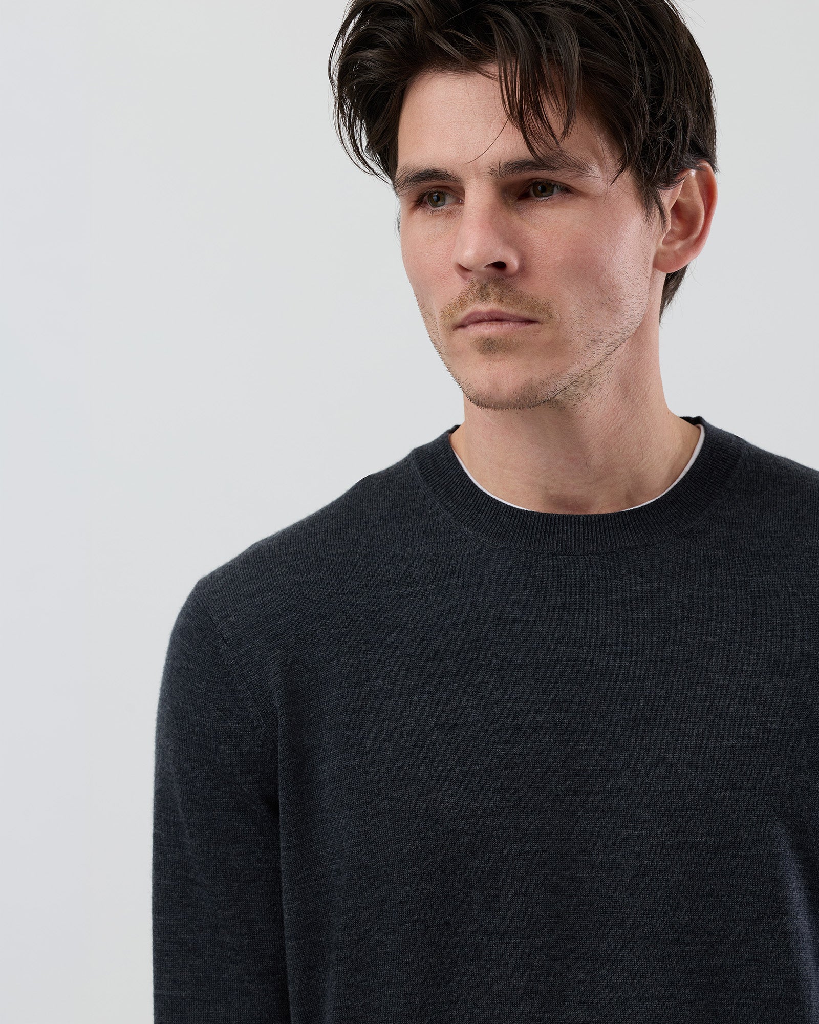 Close-up front view of a men's charcoal marl Australian ultrafine merino wool crew neck sweater highlighting the fine knit texture and premium Australian wool.