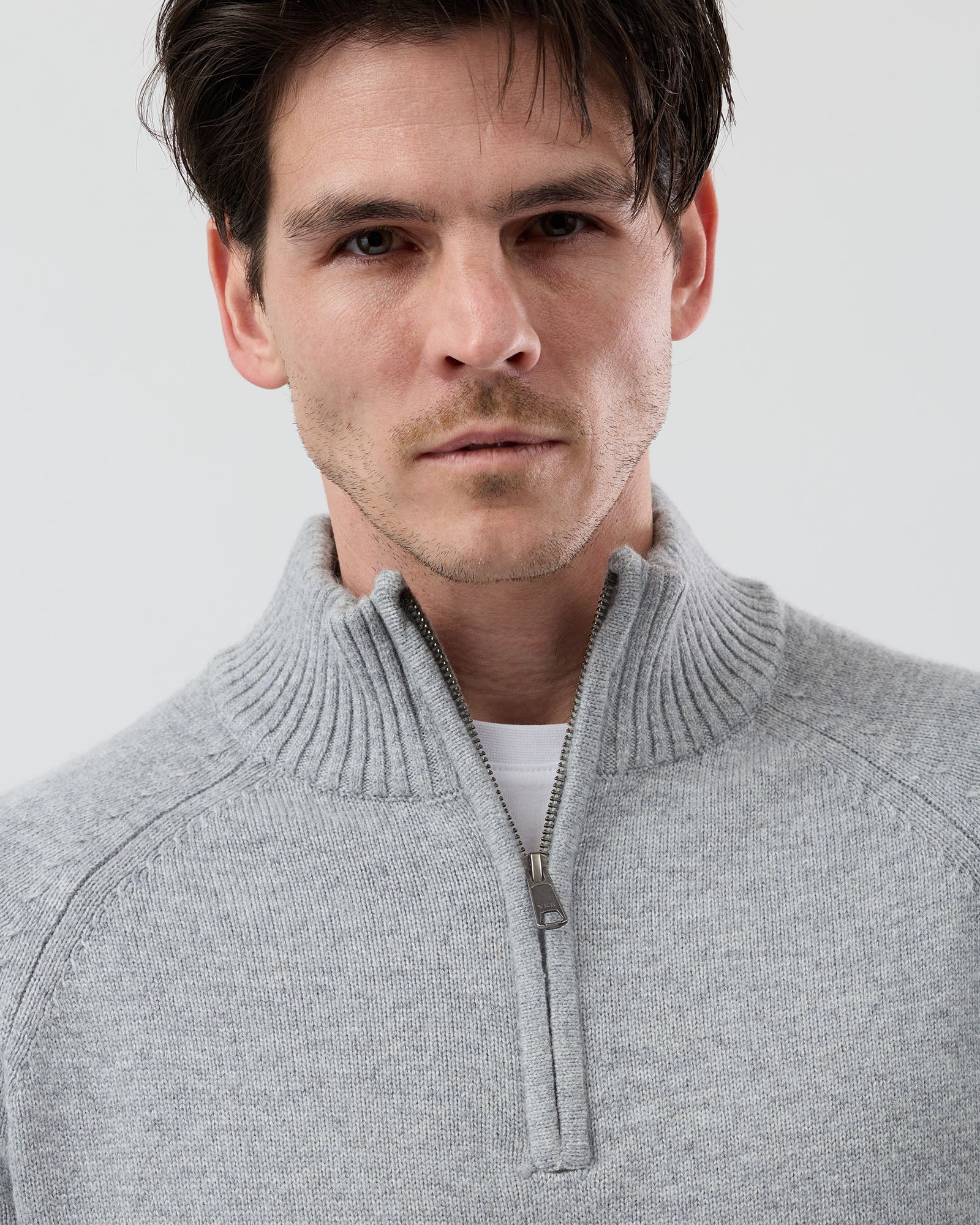 Close-up front view of the Wayver light grey wool blend half zip knit showing the YKK metal zip, stand collar and premium knit finish.