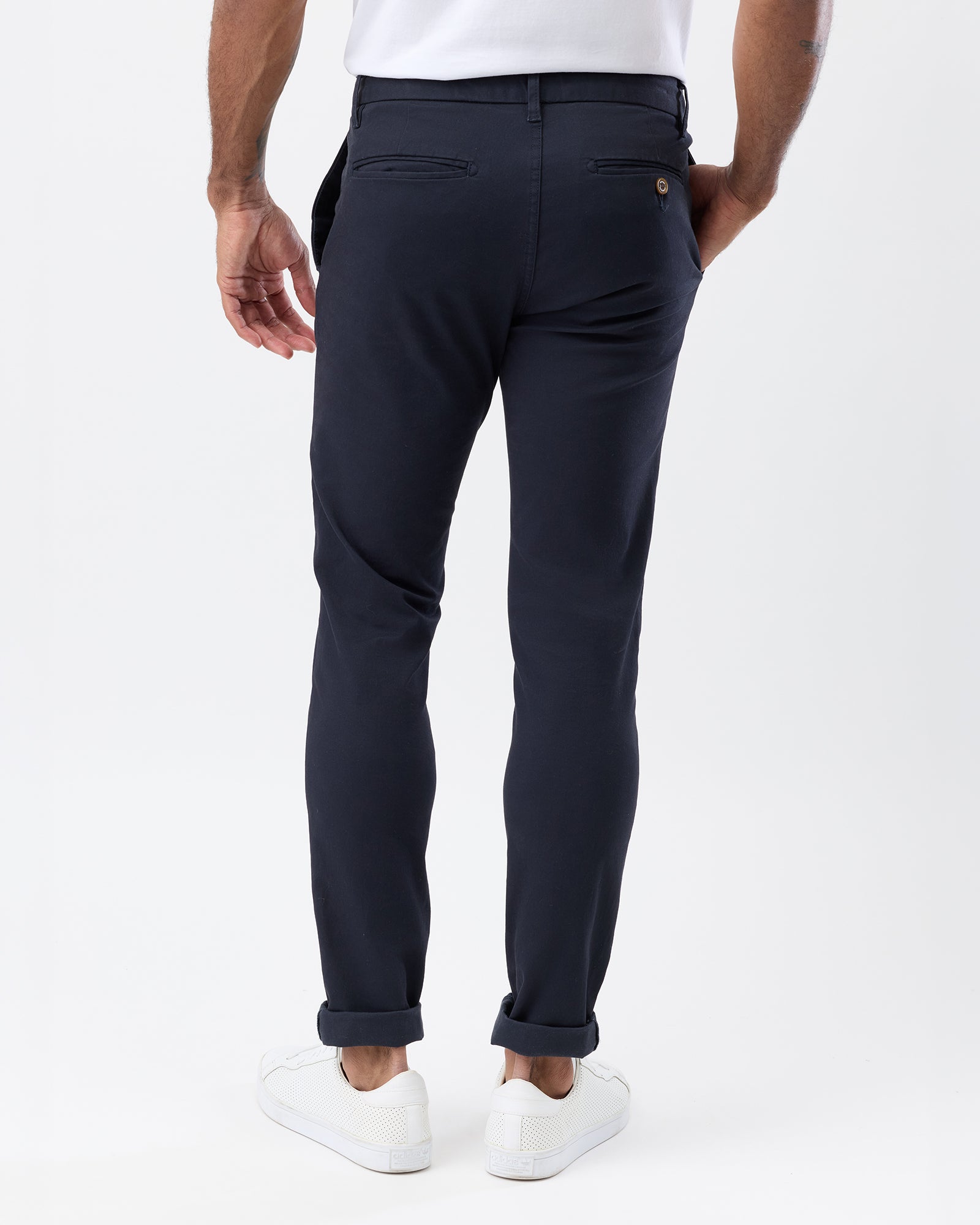Rear view of Wayver Originals men's navy slim fit chinos showing the tapered legs, welt back pockets and button fastening.