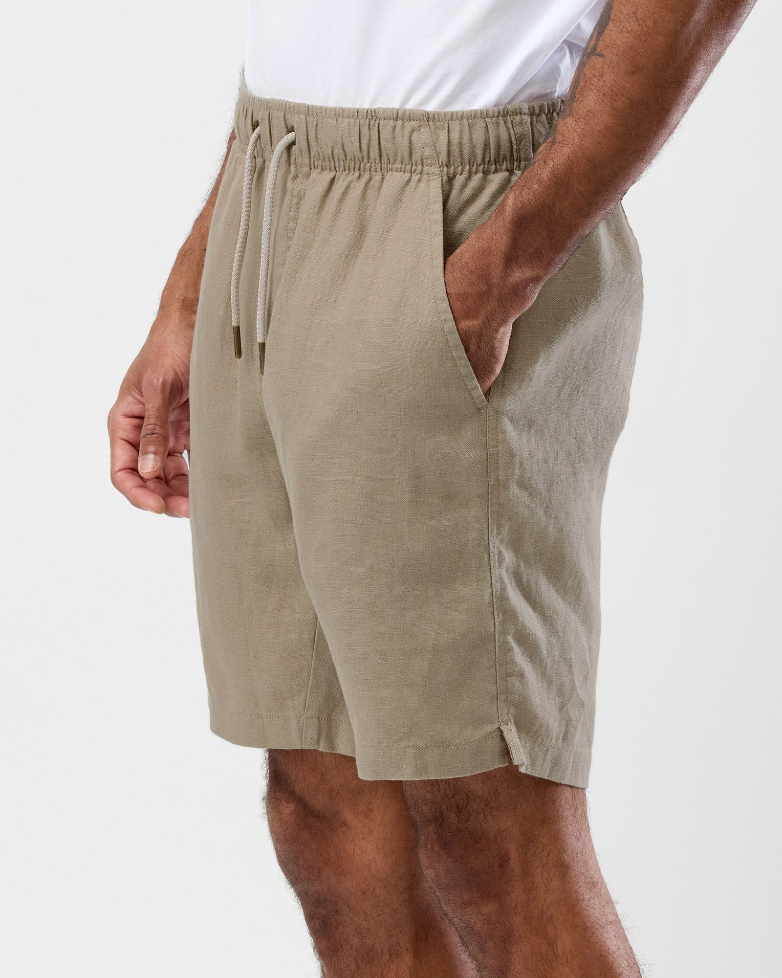 Men's oat linen shorts side view showing relaxed fit and side pocket