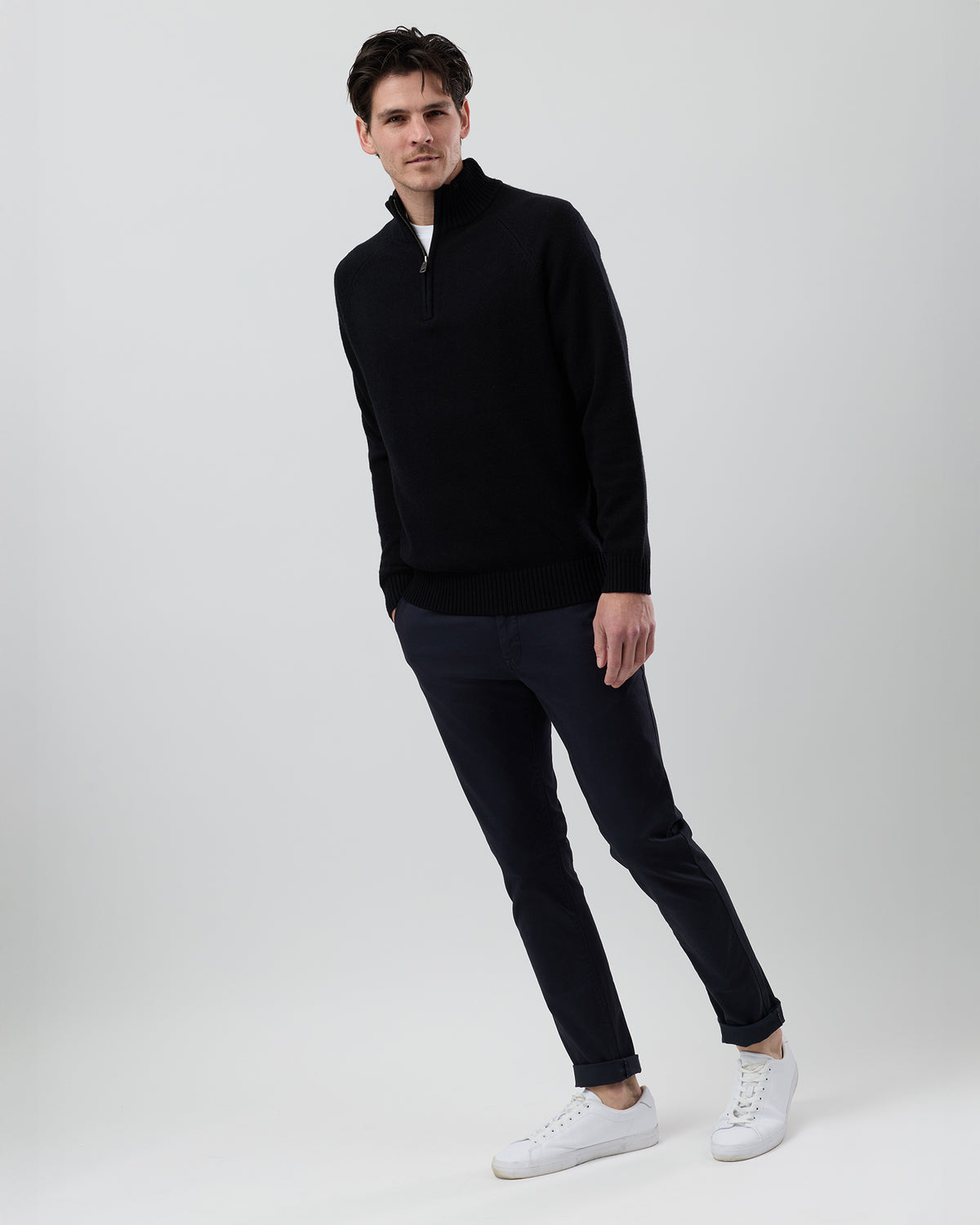 Full-length side profile of a men's black wool blend quarter zip jumper showing the regular fit and slim sleeve shape.