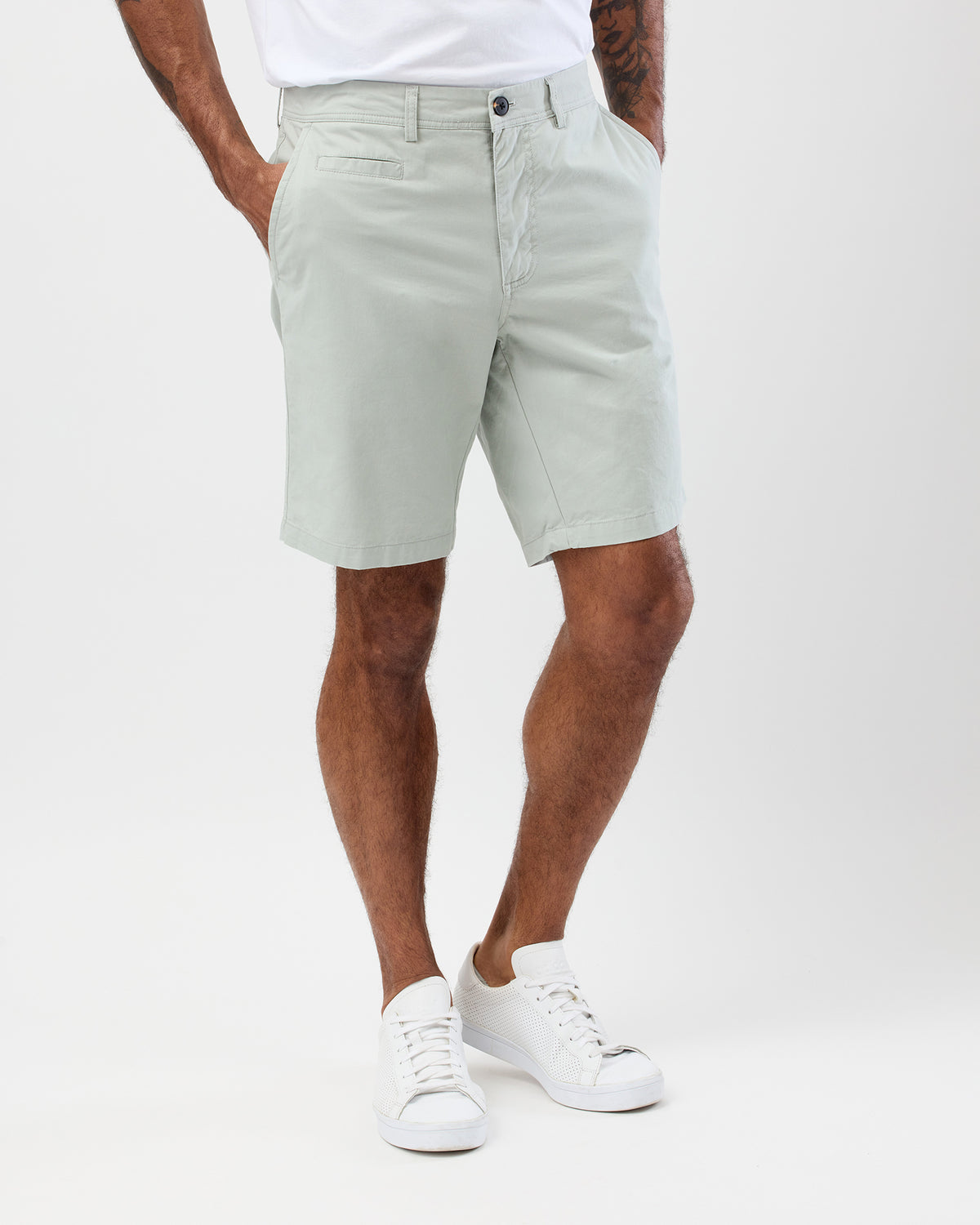 Fatigue Green Bermuda Shorts Styled Casually with a tucked in white t-shirt and white sneakers - Men's Summer Outfit