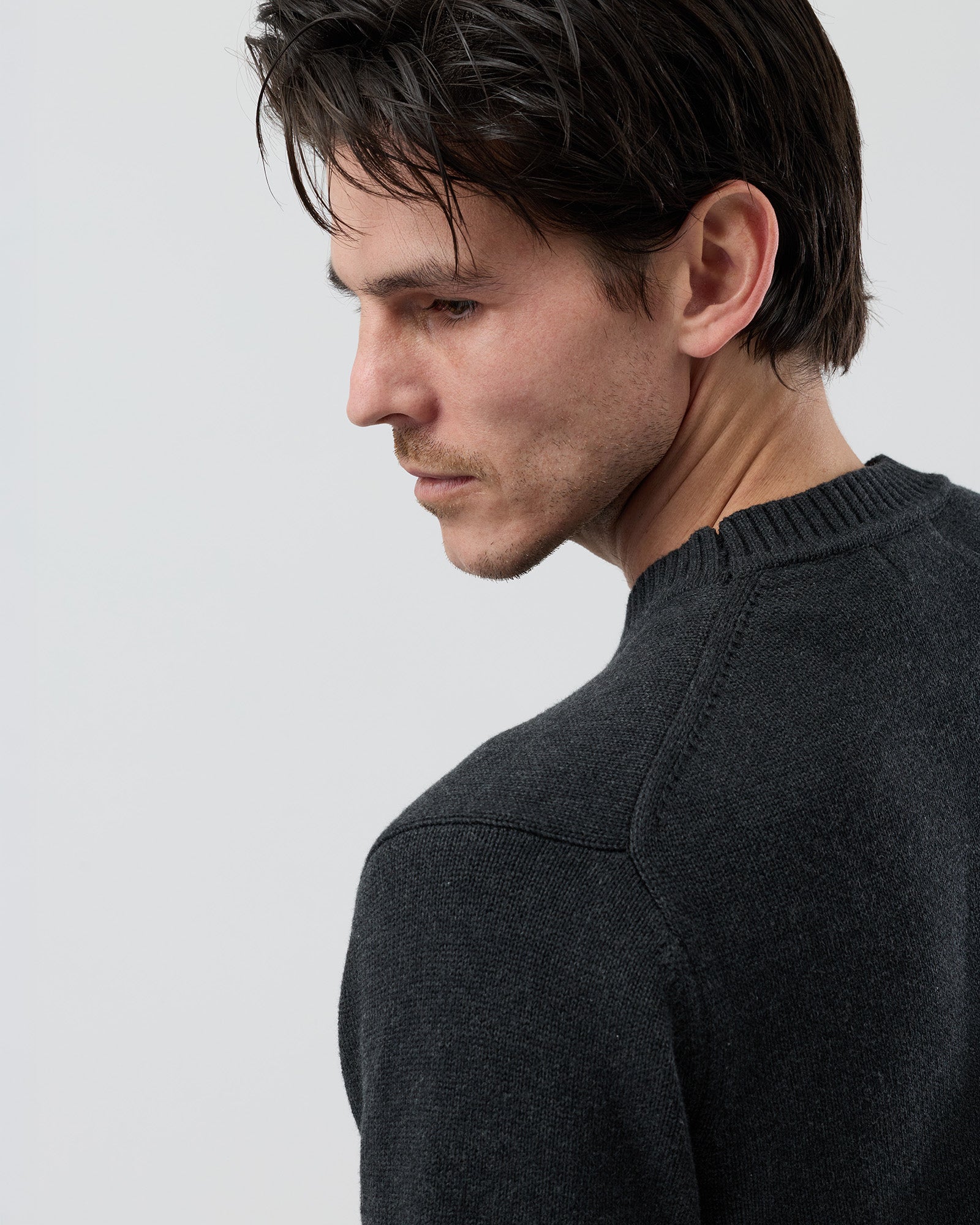 Close-up rear detail of the Wayver charcoal cotton crew neck knit showing the 2x2 rib detailing and fine cotton knit texture.