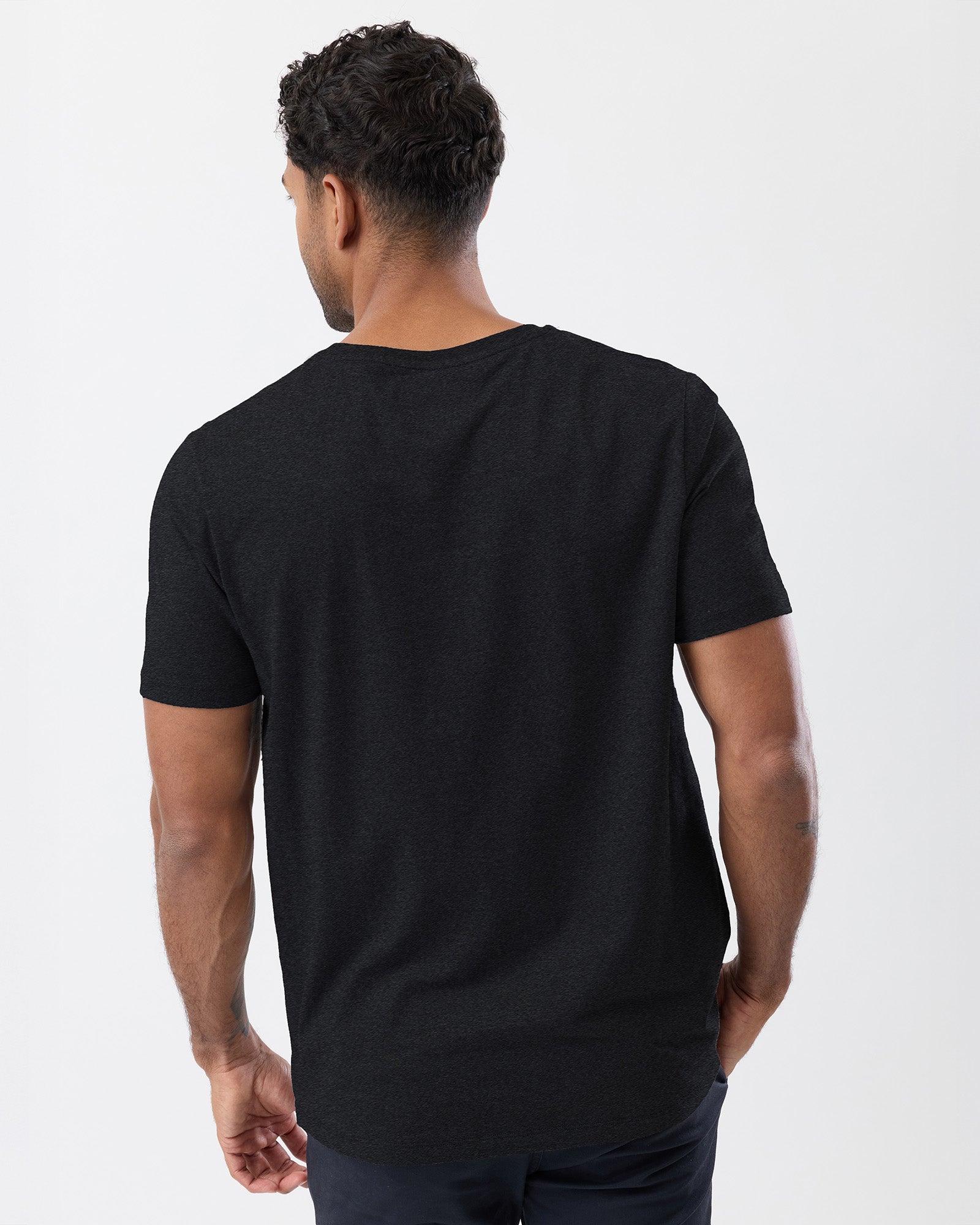 Man wearing a black t-shirt on a white background, rear view