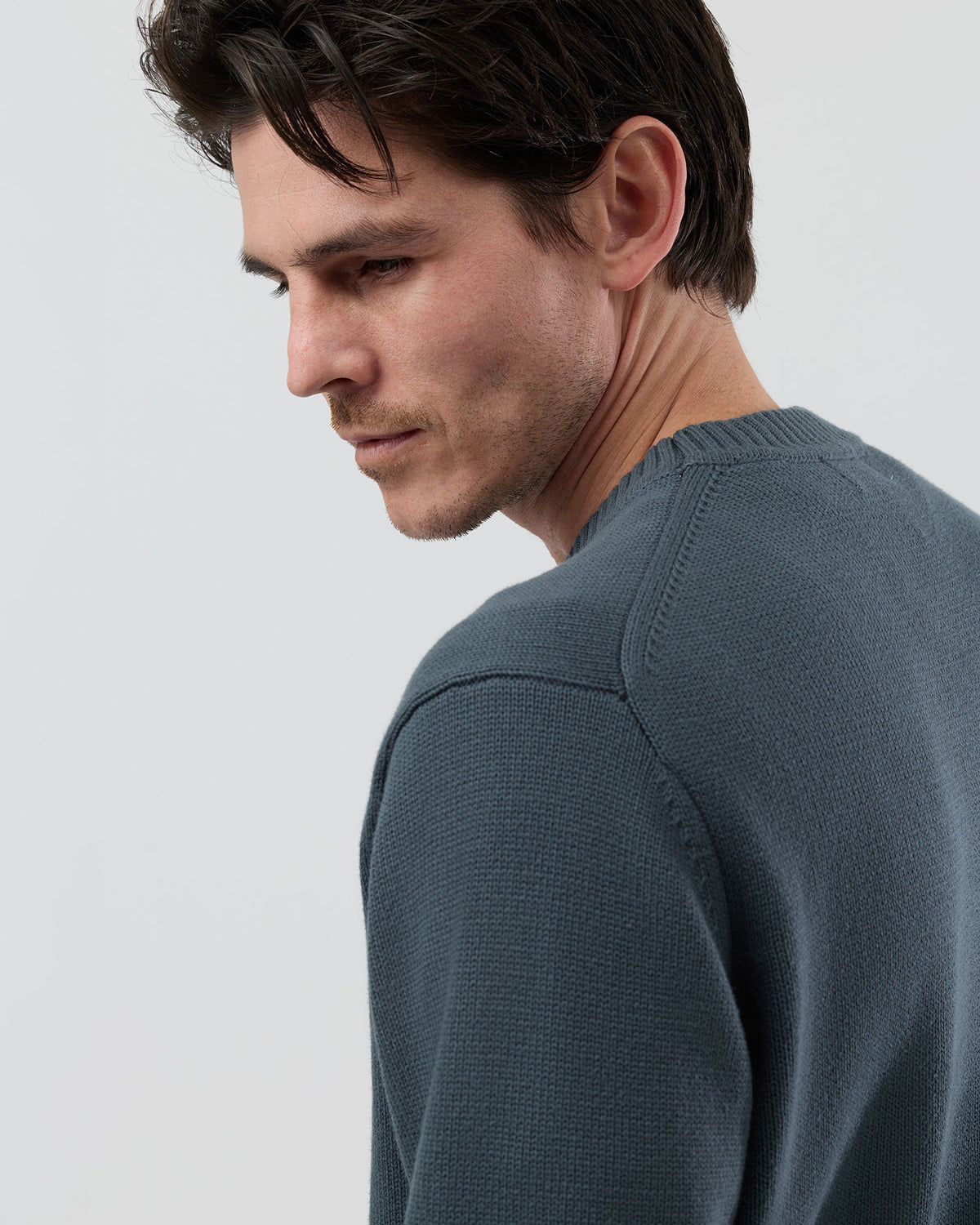 Close-up rear detail of the Wayver ironstone cotton crew neck knit showing the 2x2 rib detailing and quality cotton knit construction.