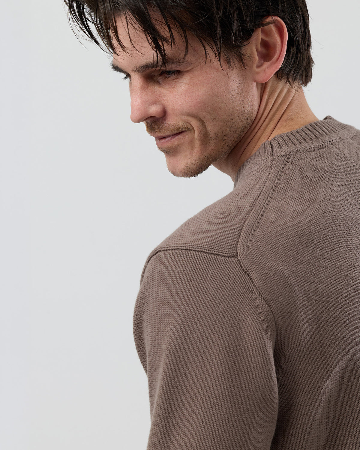 Close-up rear detail of the Wayver latte cotton crew neck knit showing the 2x2 rib construction and fine cotton texture.
