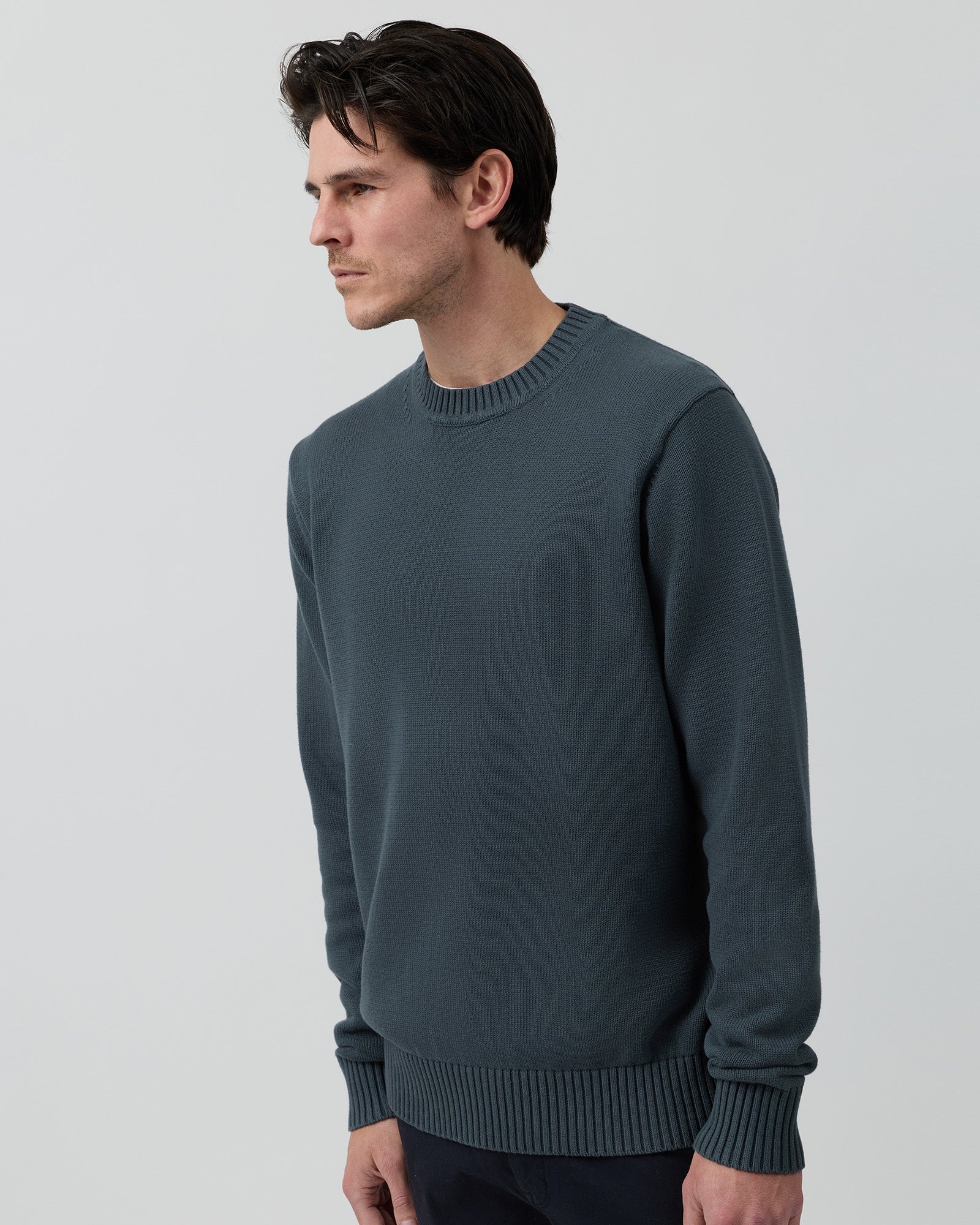 Angled side view of the Wayver ironstone 100% cotton crew neck knit showing the clean silhouette and premium cotton texture.