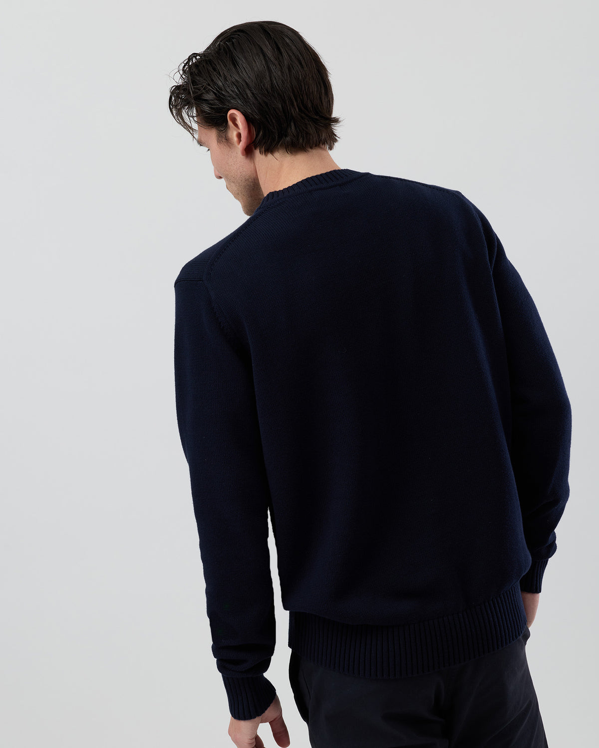 Rear view of the Wayver navy cotton crew neck jumper showing the clean back profile, ribbed hem and timeless knit design.