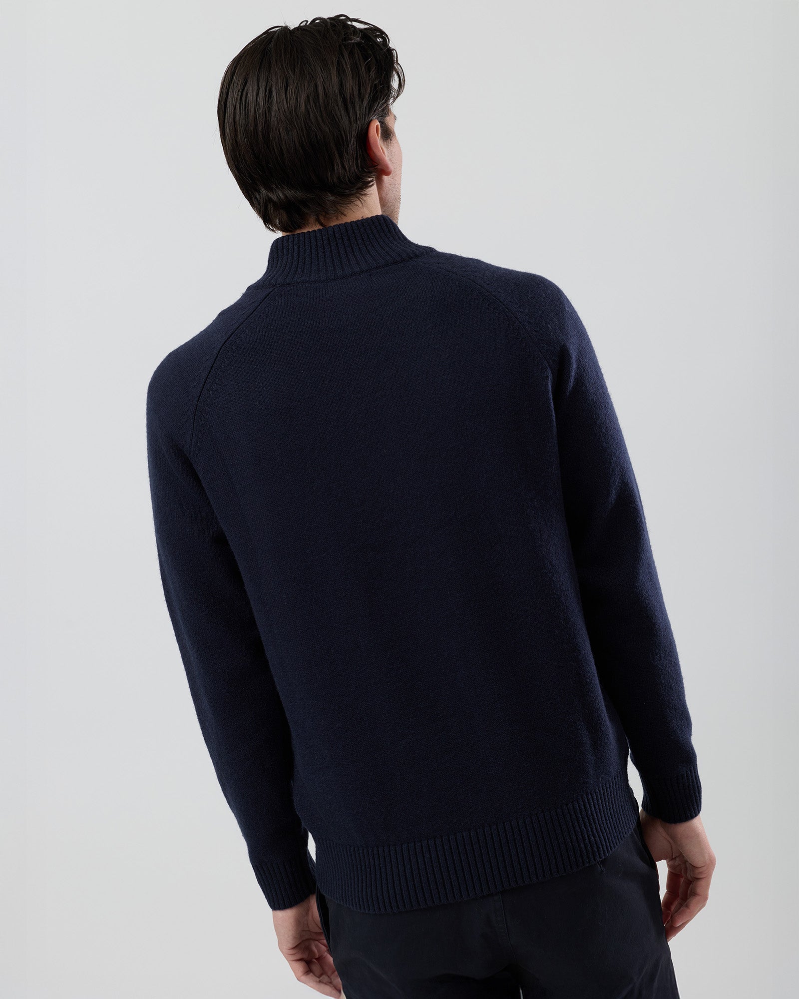 Rear view of the Wayver navy wool blend stand collar jumper showing the clean shape and classic knit construction.