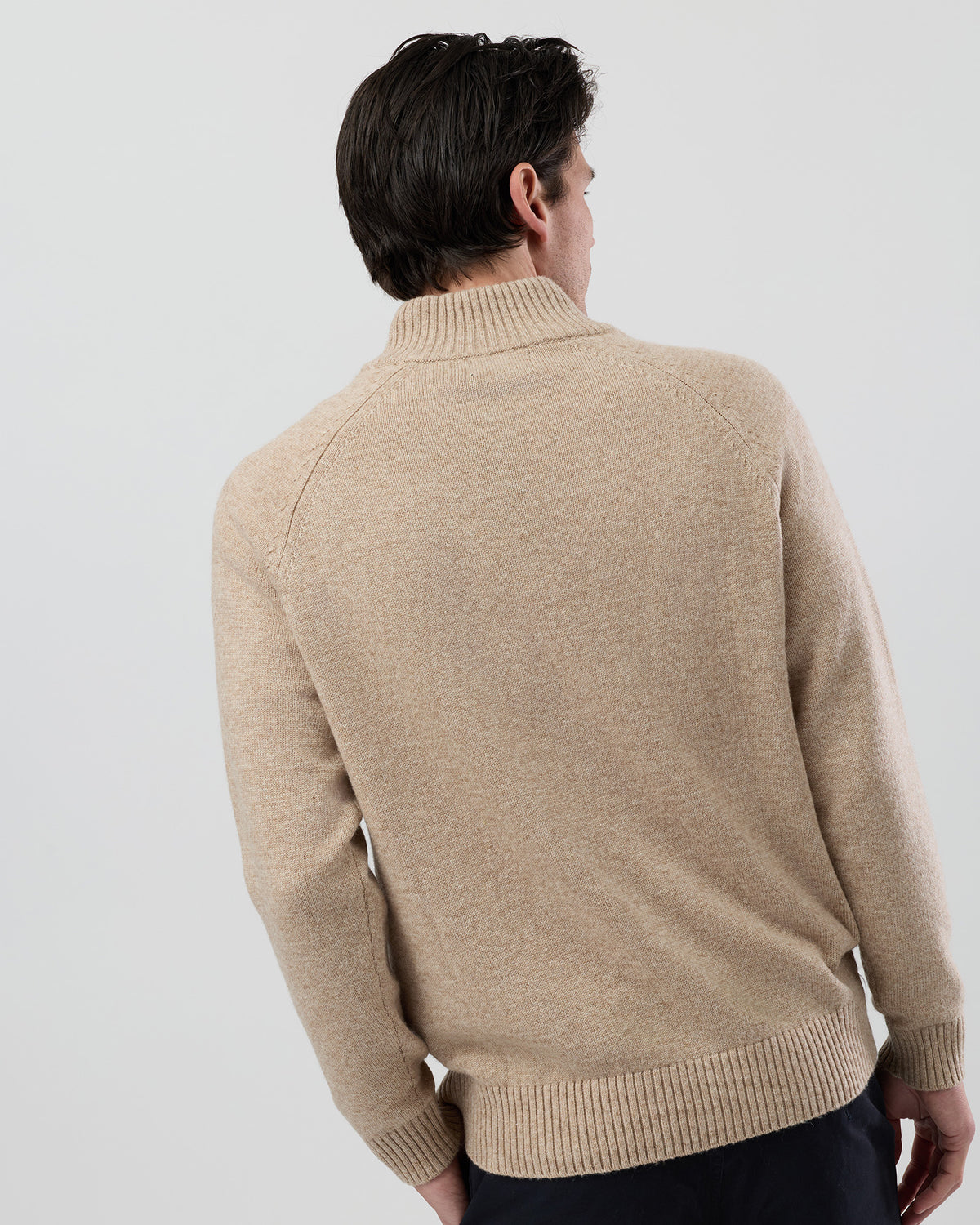 Rear view of the Wayver oatmeal wool blend stand collar jumper showing the clean shape and classic knit construction.