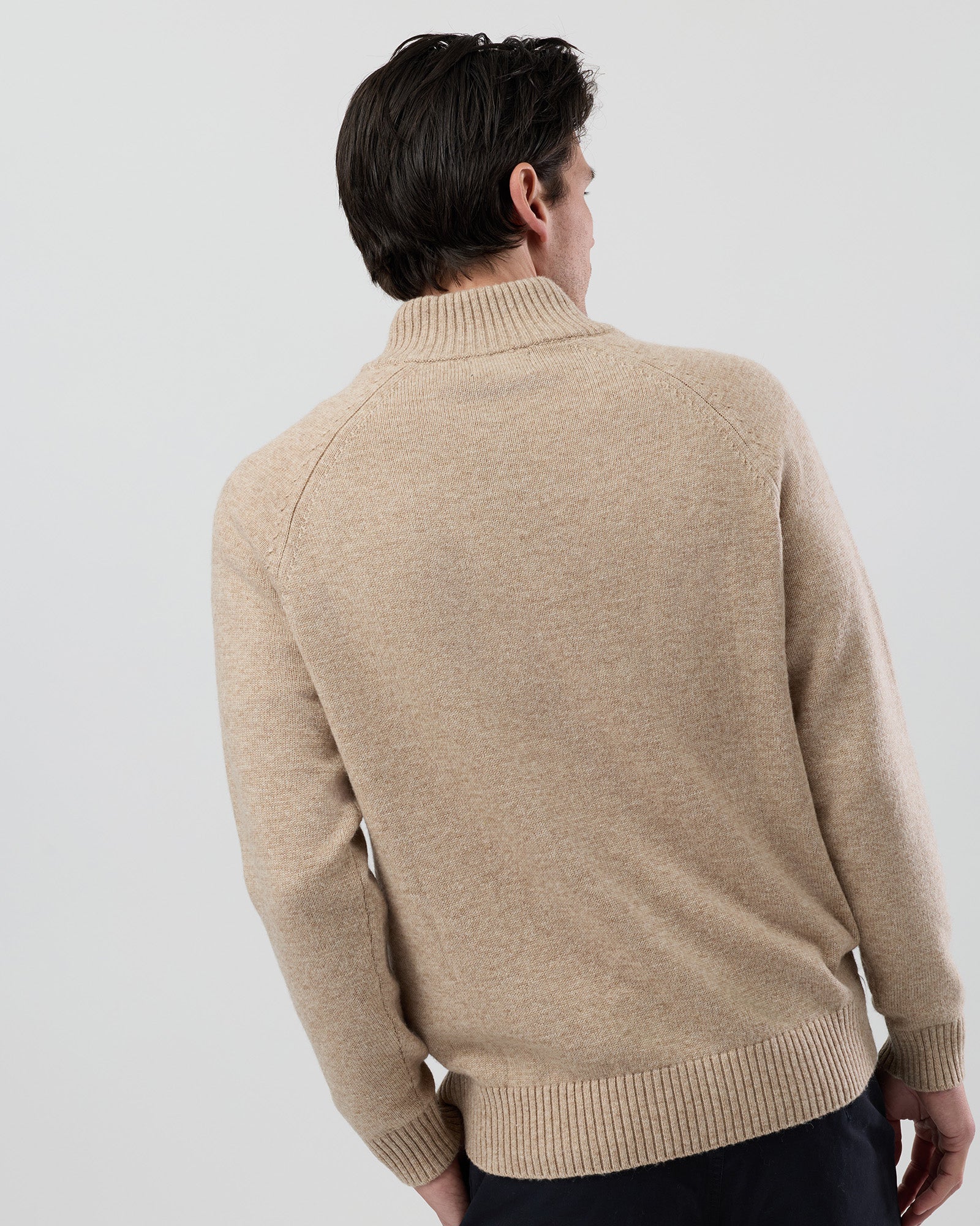 Rear view of the Wayver oatmeal wool blend stand collar jumper showing the clean shape and classic knit construction.