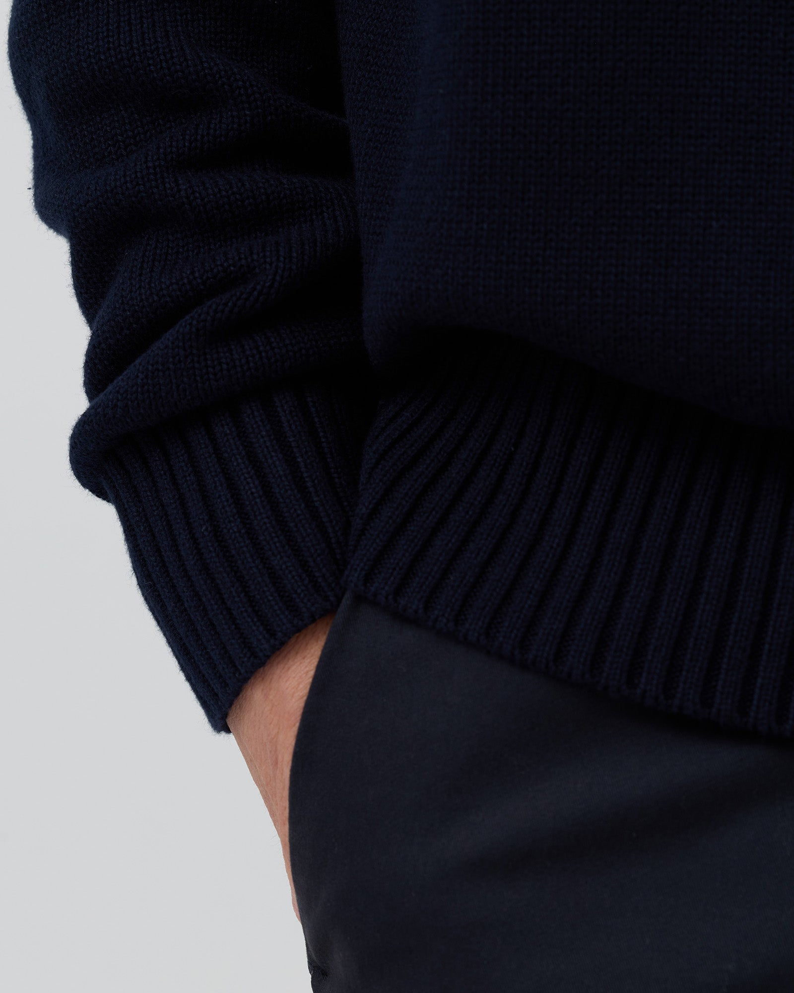 Close-up front view of the Wayver navy 100% cotton crew neck knit highlighting the soft natural cotton texture and premium construction.
