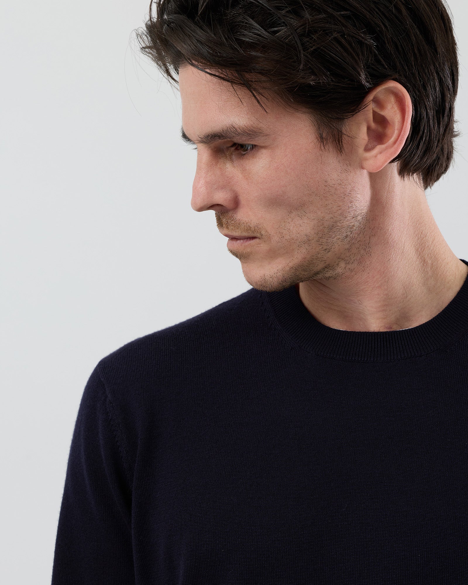 Close-up front view of a men's navy Australian ultrafine merino wool crew neck jumper showing the fine knit texture and premium finish.