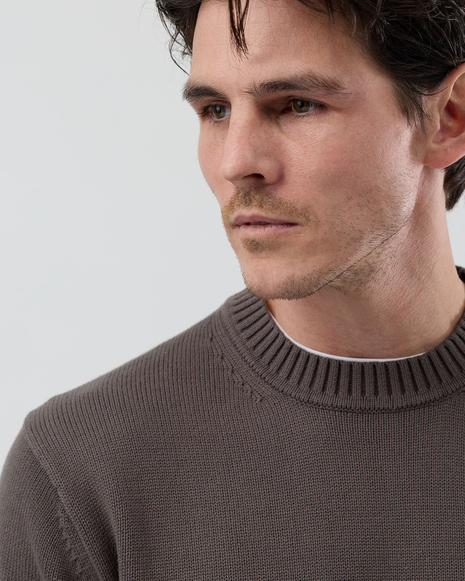 Close-up front view of the Wayver slate brown 100% cotton crew neck knit highlighting the natural cotton texture and refined finish.