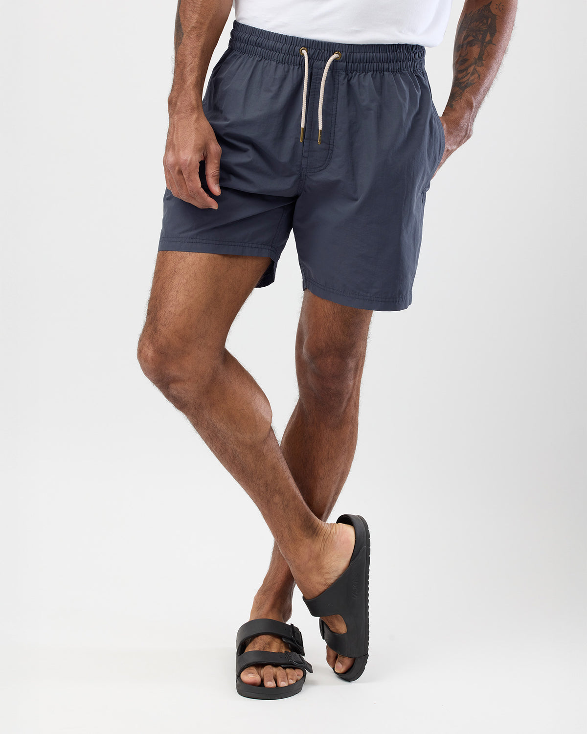 Person wearing vintage blue shorts on a white background