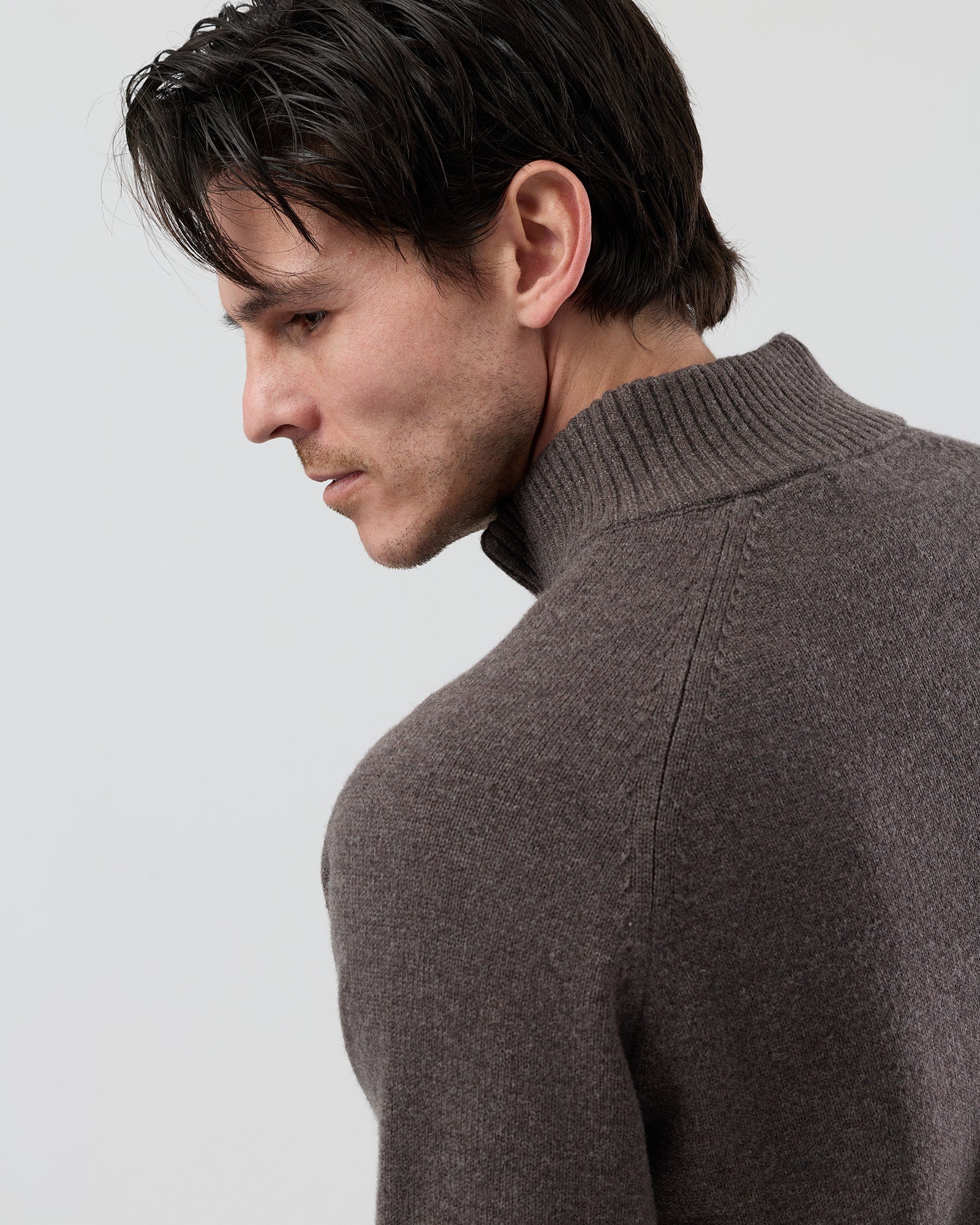 Close-up rear shoulder detail of the Wayver brown marl wool blend knit showing the structured shoulder construction, stand collar shape and marl yarn texture.