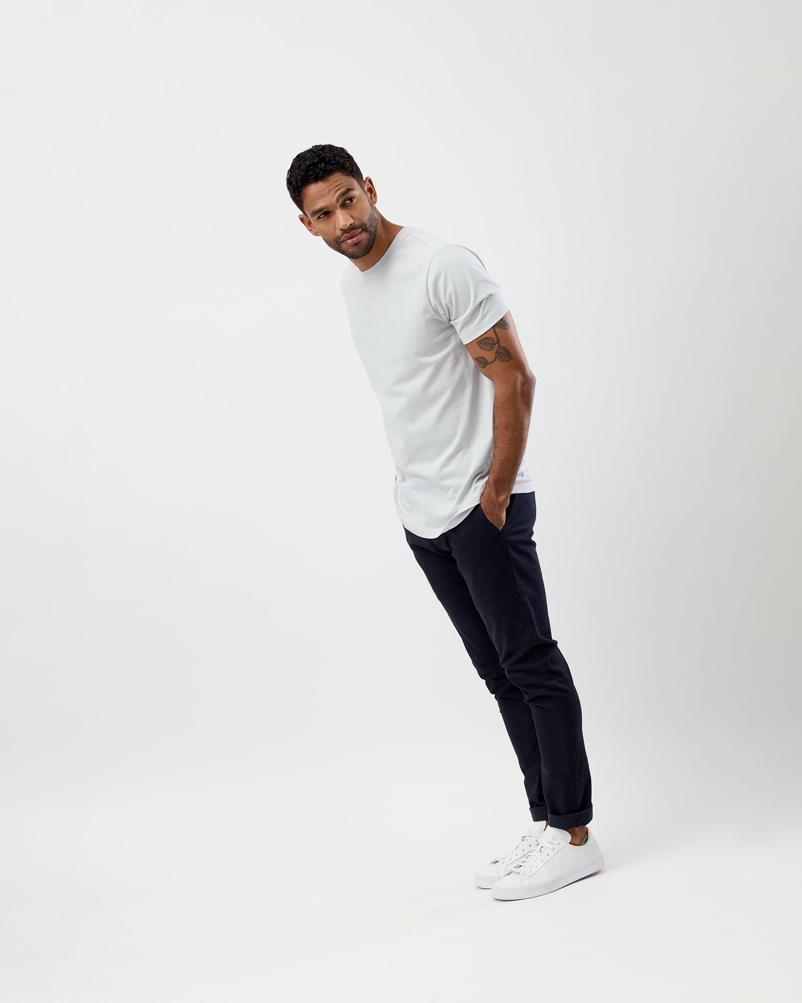 Model wearing men's Glacier Coloured Essential crew t-shirt with casual chino pants