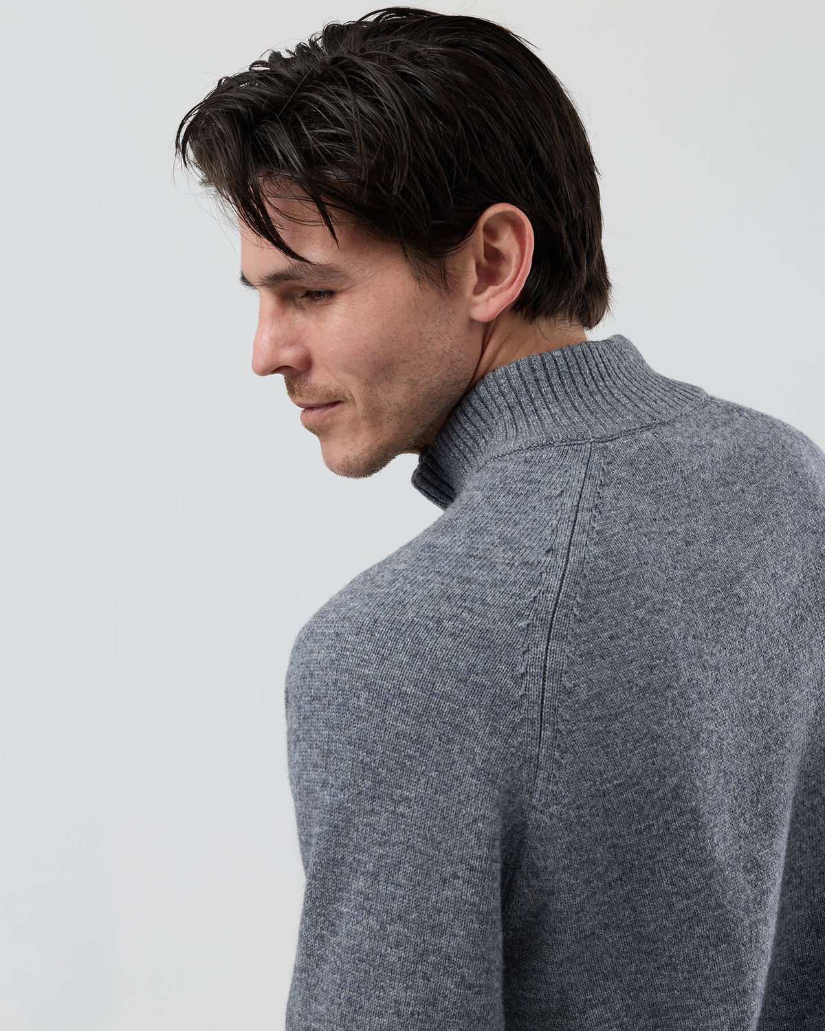 Close-up rear shoulder detail of the Wayver grey wool blend knit showing the structured shoulder construction, stand collar shape and premium jersey knit texture.