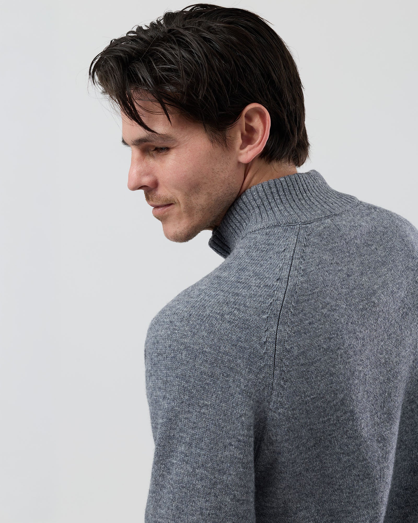 Full-length side profile of a men's grey wool blend quarter zip jumper showing the regular fit and slim sleeve shape.