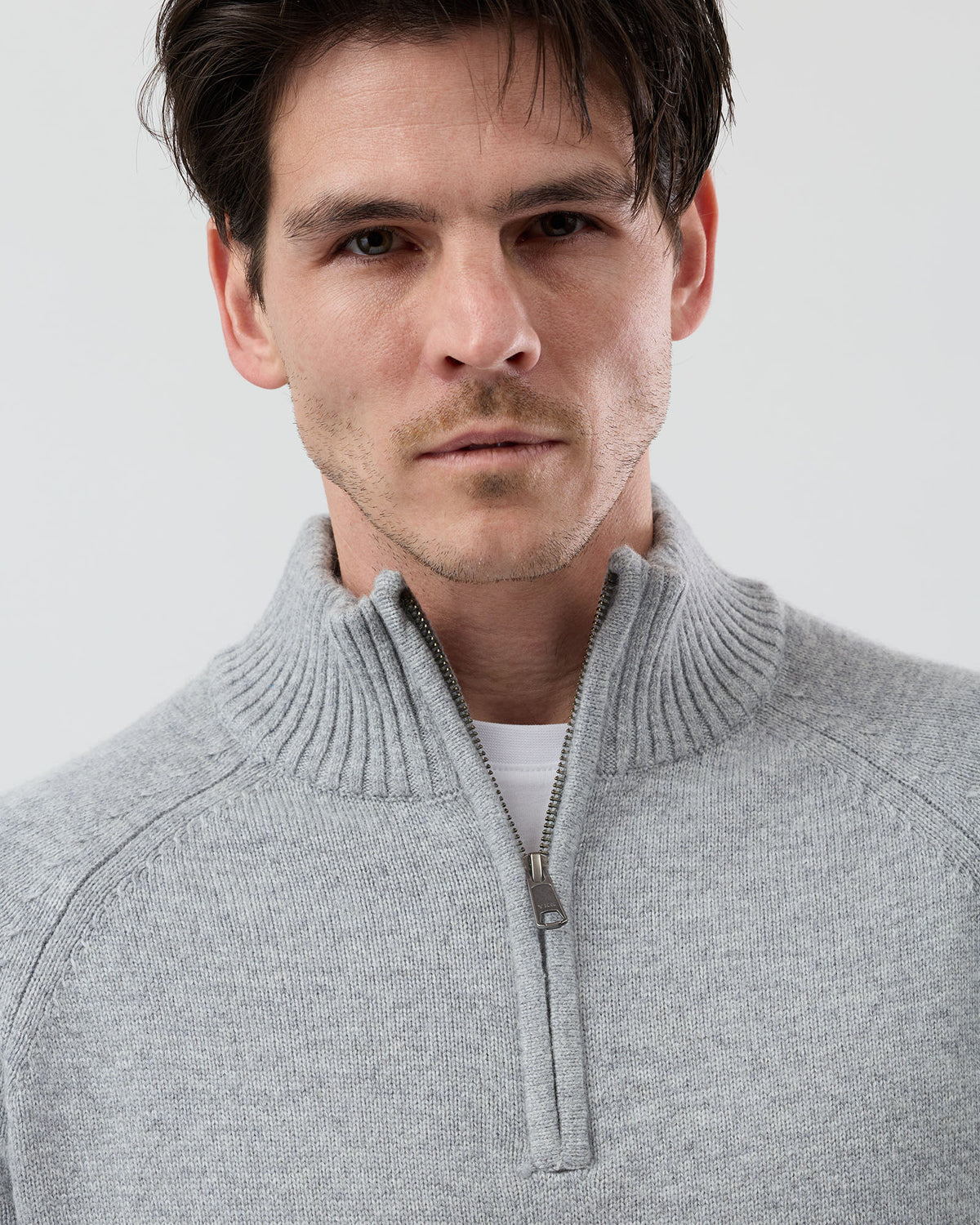 Close-up front view of the Wayver light grey wool blend half zip knit showing the YKK metal zip, stand collar and premium knit finish.