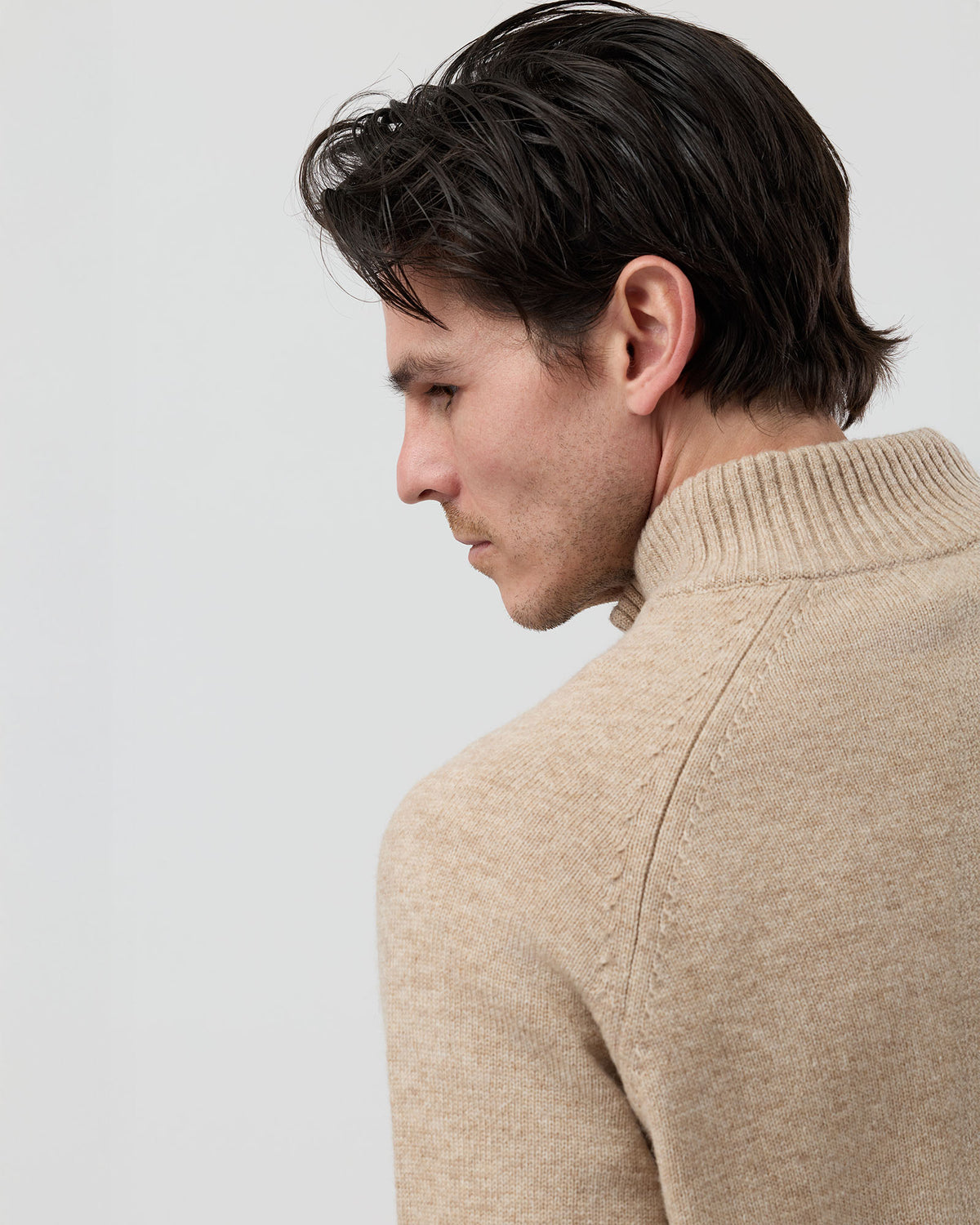Close-up rear shoulder detail of the Wayver oatmeal wool blend knit showing the structured shoulder construction, stand collar shape and premium knit texture.