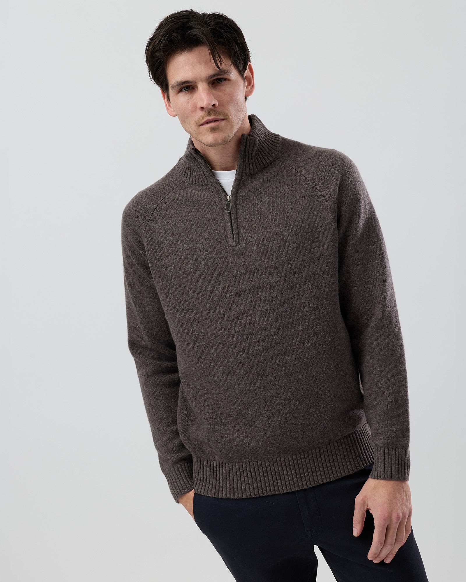Male model wearing the Wayver brown marl wool blend half zip knit, front view showing the stand collar, regular fit and slim sleeve design on a grey background.