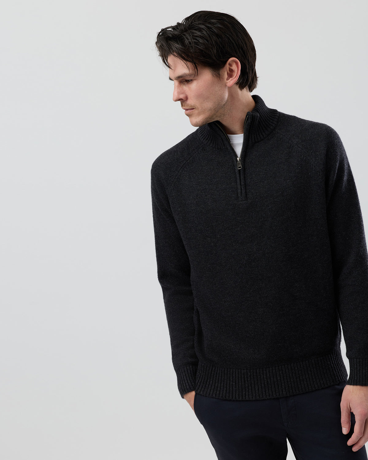Male model wearing the Wayver charcoal wool blend half zip knit, front view showing the stand collar, regular fit and slim sleeve profile on a grey background.