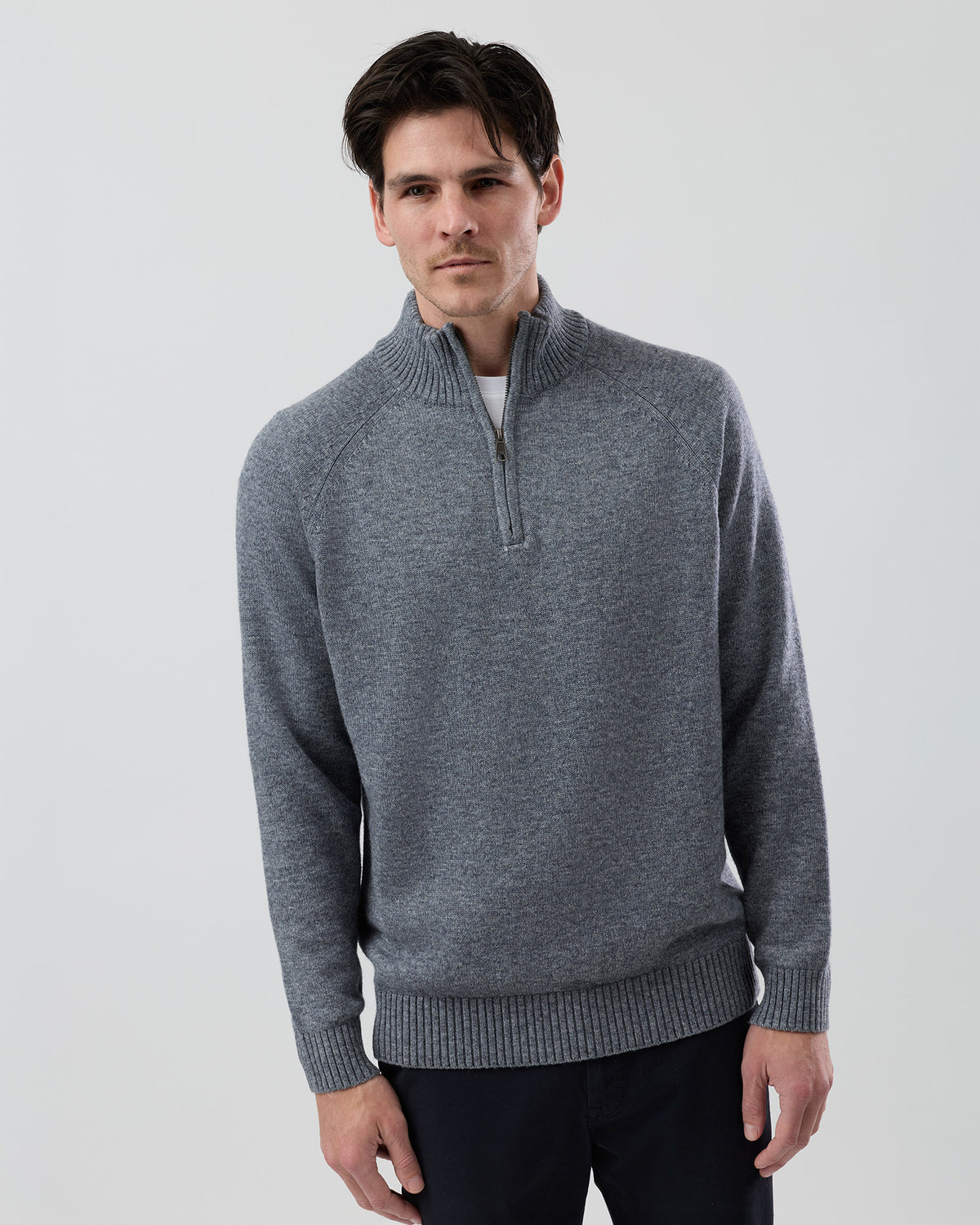 Male model wearing the Wayver grey wool blend half zip knit, front view showing the stand collar, regular fit and slim sleeve design on a grey background.