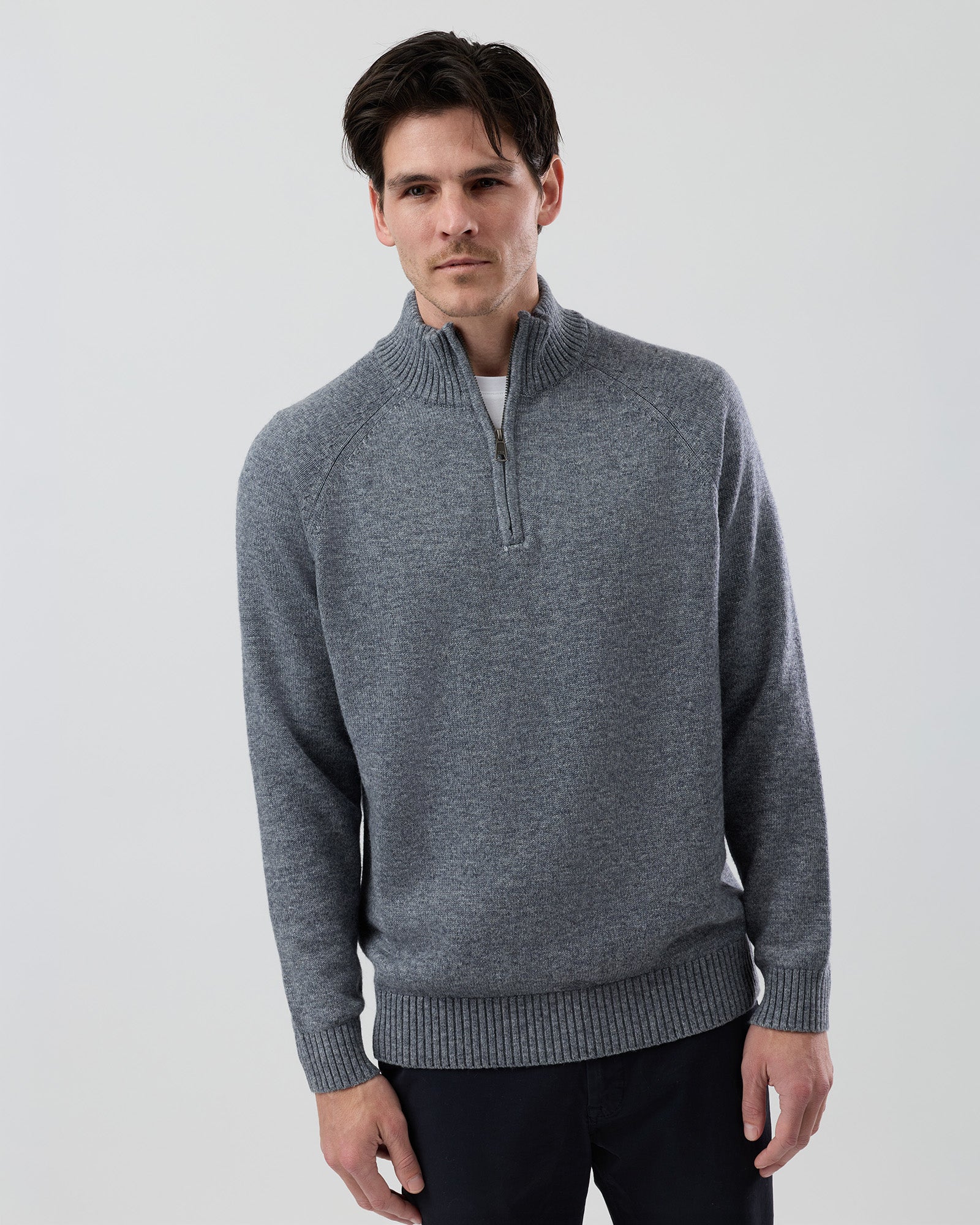 Male model wearing the Wayver grey wool blend half zip knit, front view showing the stand collar, regular fit and slim sleeve design on a grey background.
