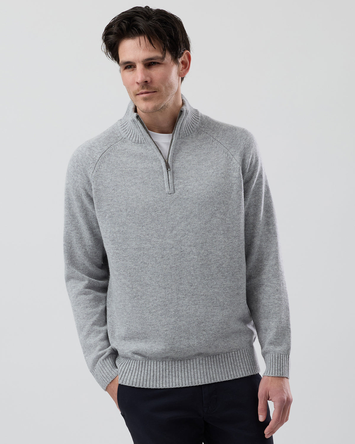Male model wearing the Wayver light grey wool blend half zip knit, front view showing the stand collar, regular fit and slim sleeves on a grey background.