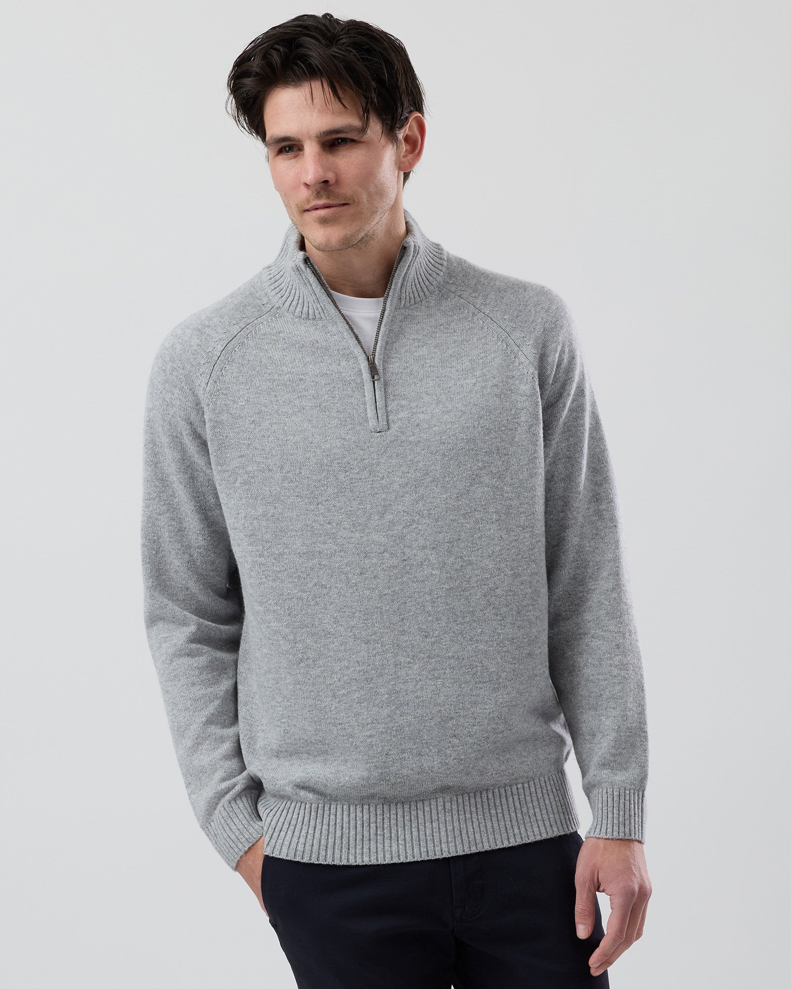 Male model wearing the Wayver light grey wool blend half zip knit, front view showing the stand collar, regular fit and slim sleeves on a grey background.