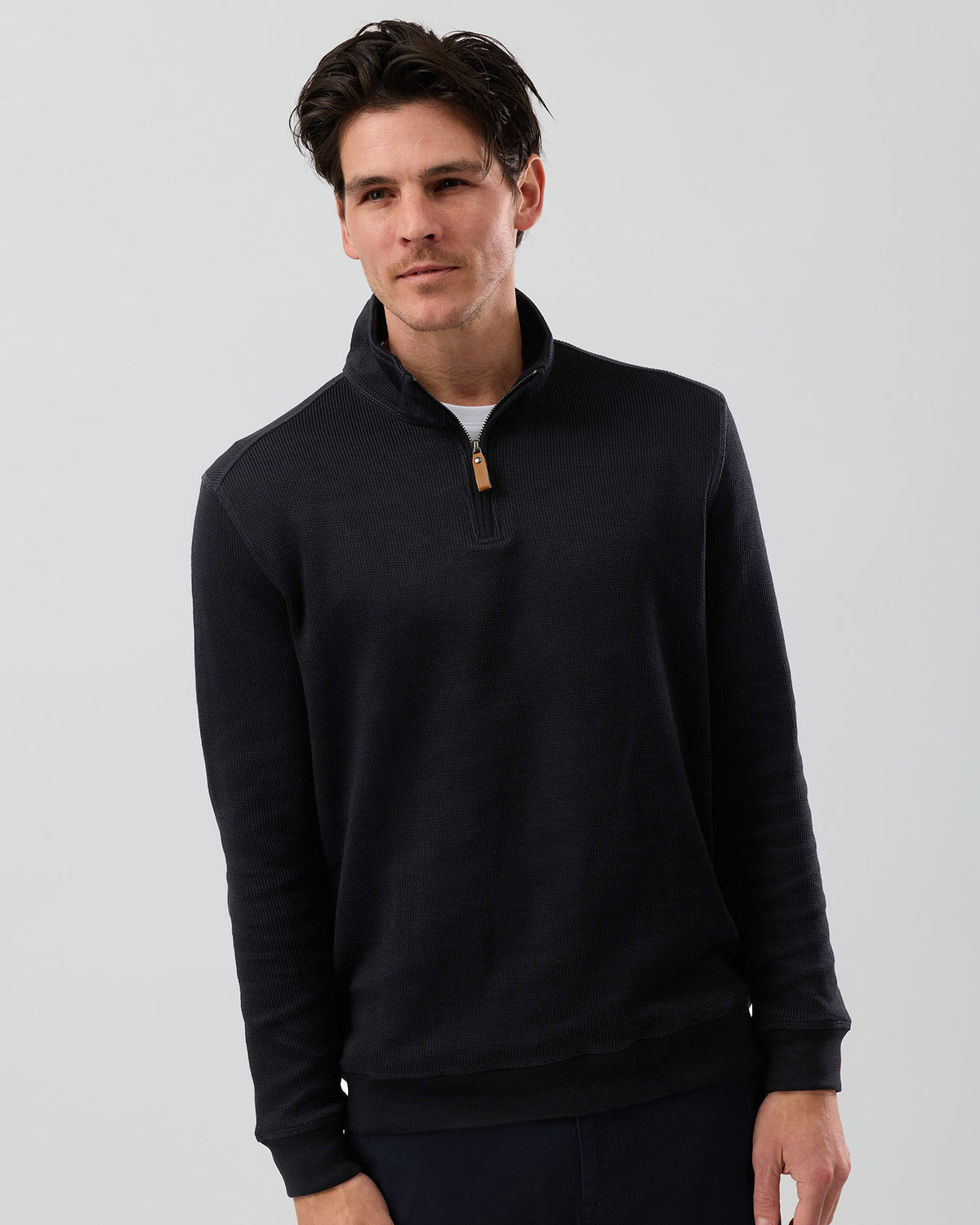 Men's black cotton-rich half zip knit sweater by Wayver Originals, featuring a textured French rib finish, quarter zip collar and comfortable regular fit.