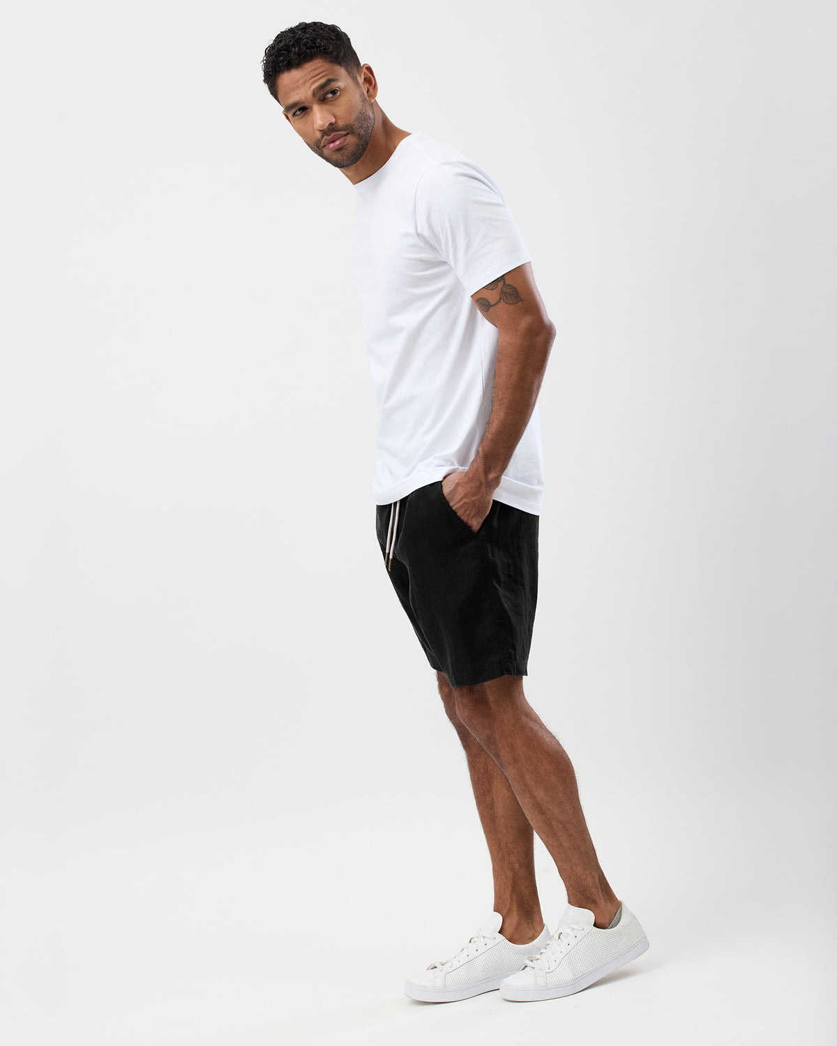 Men's black 100% linen summer shorts styled with a white T-shirt
