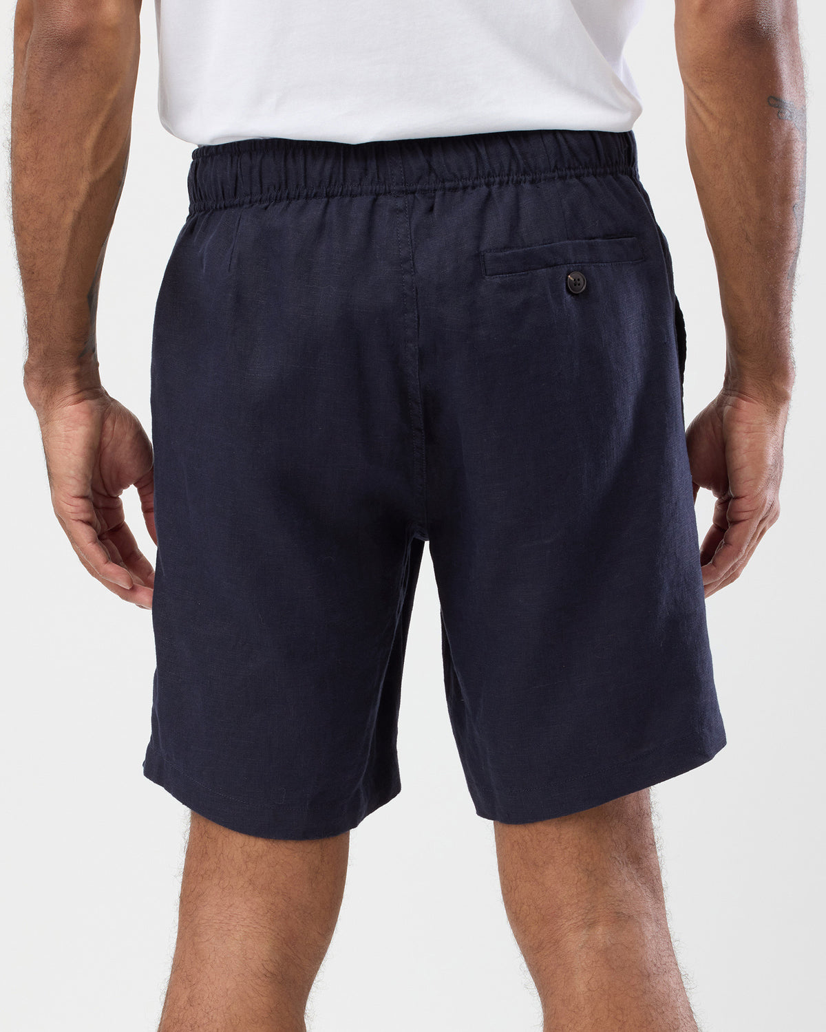 Men's navy linen shorts back view with elastic waist and buttoned back pocket