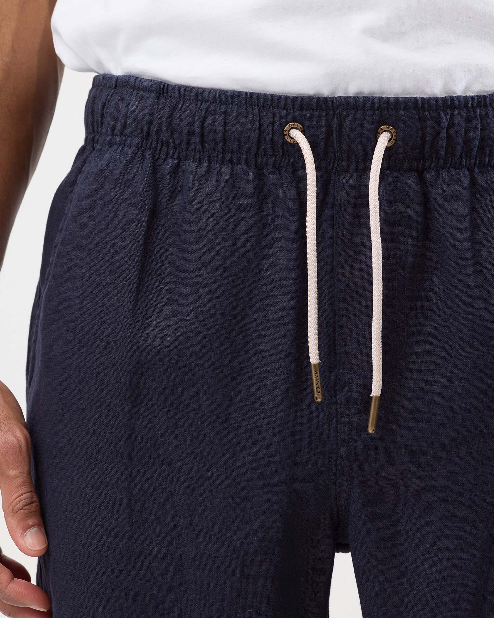 Navy linen shorts with elastic waistband, drawstring and metal eyelet detail
