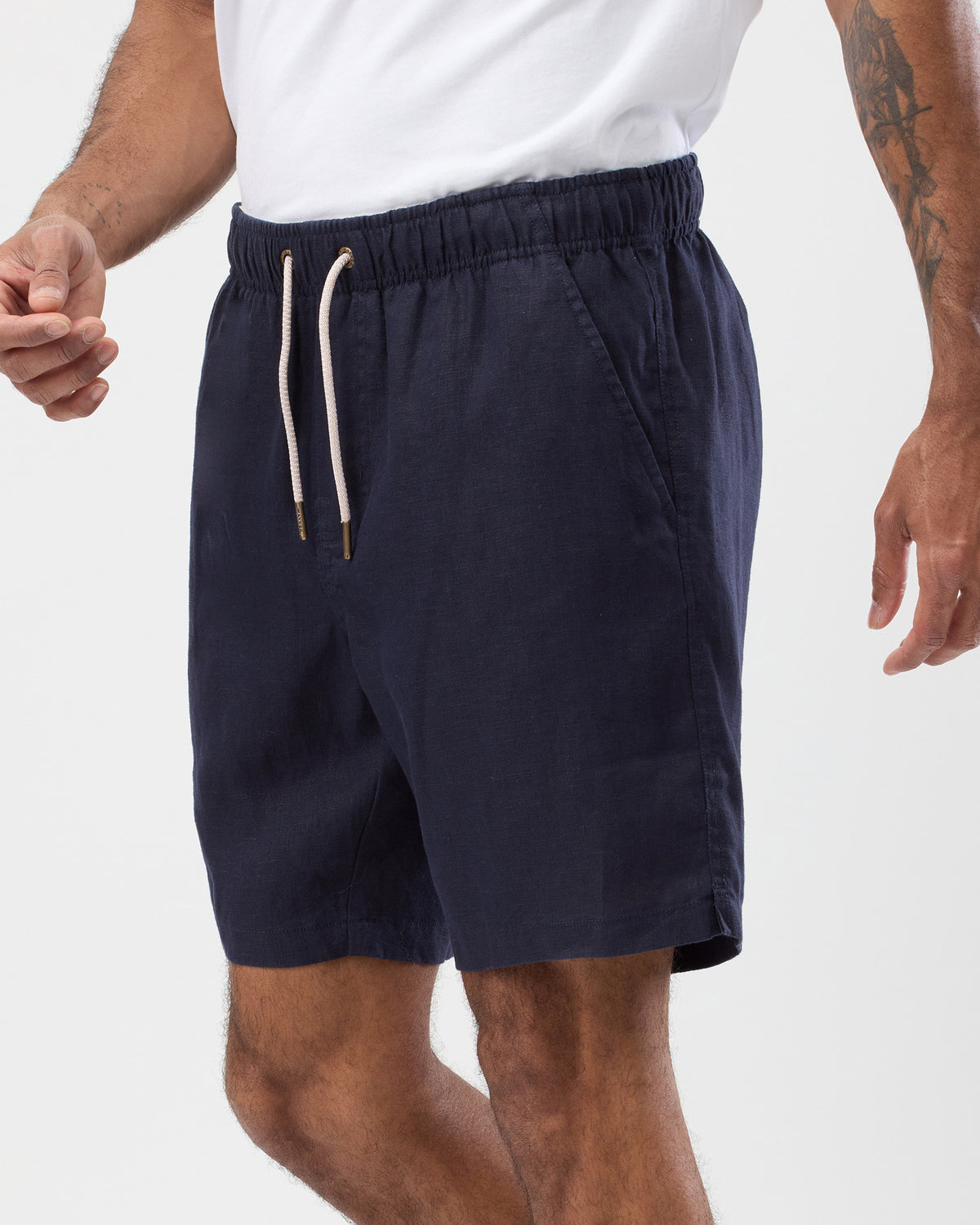 Men's navy linen shorts side view showing relaxed fit and side pocket