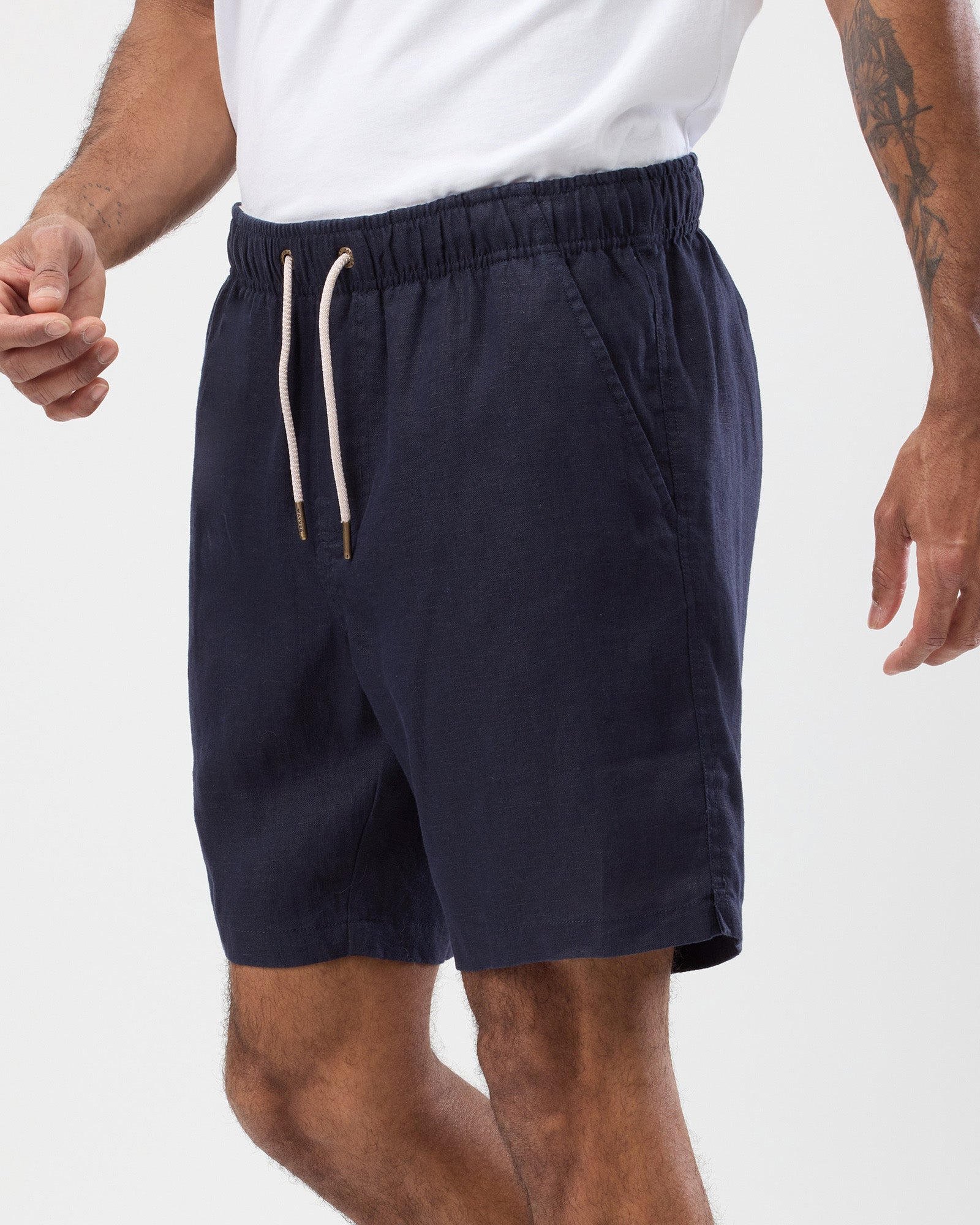 Men's navy linen shorts side view showing relaxed fit and side pocket