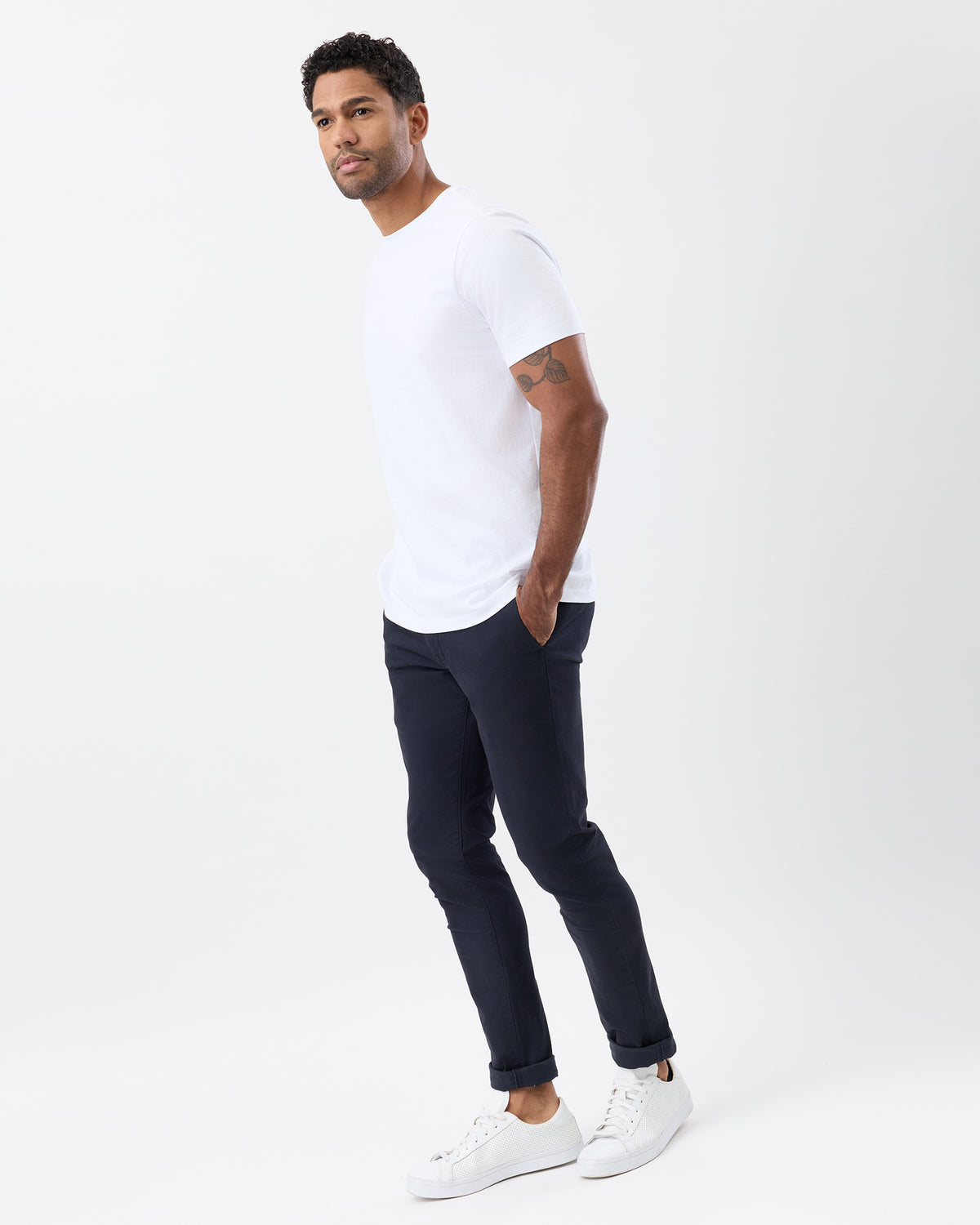 Side view of men's navy slim fit stretch cotton chinos, showing the tapered leg, rolled cuffs and smart casual styling.