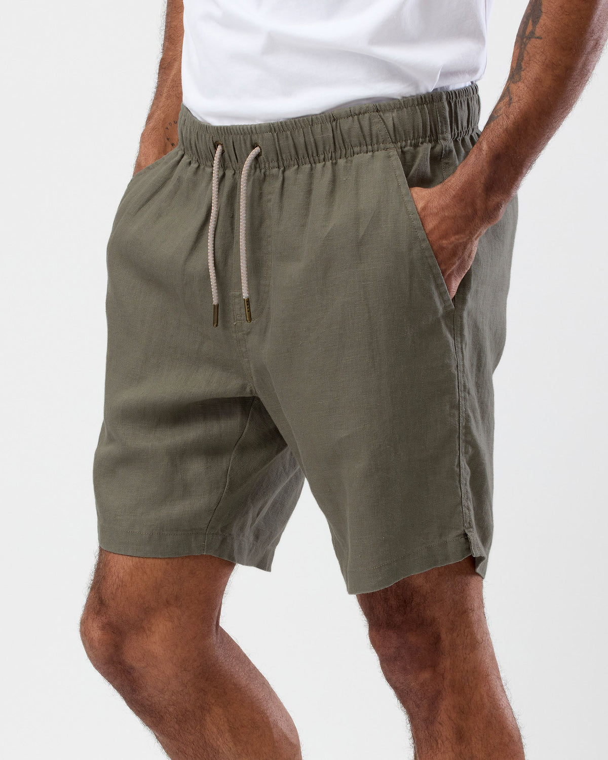 Men's olive linen shorts side view showing relaxed fit and side pocket