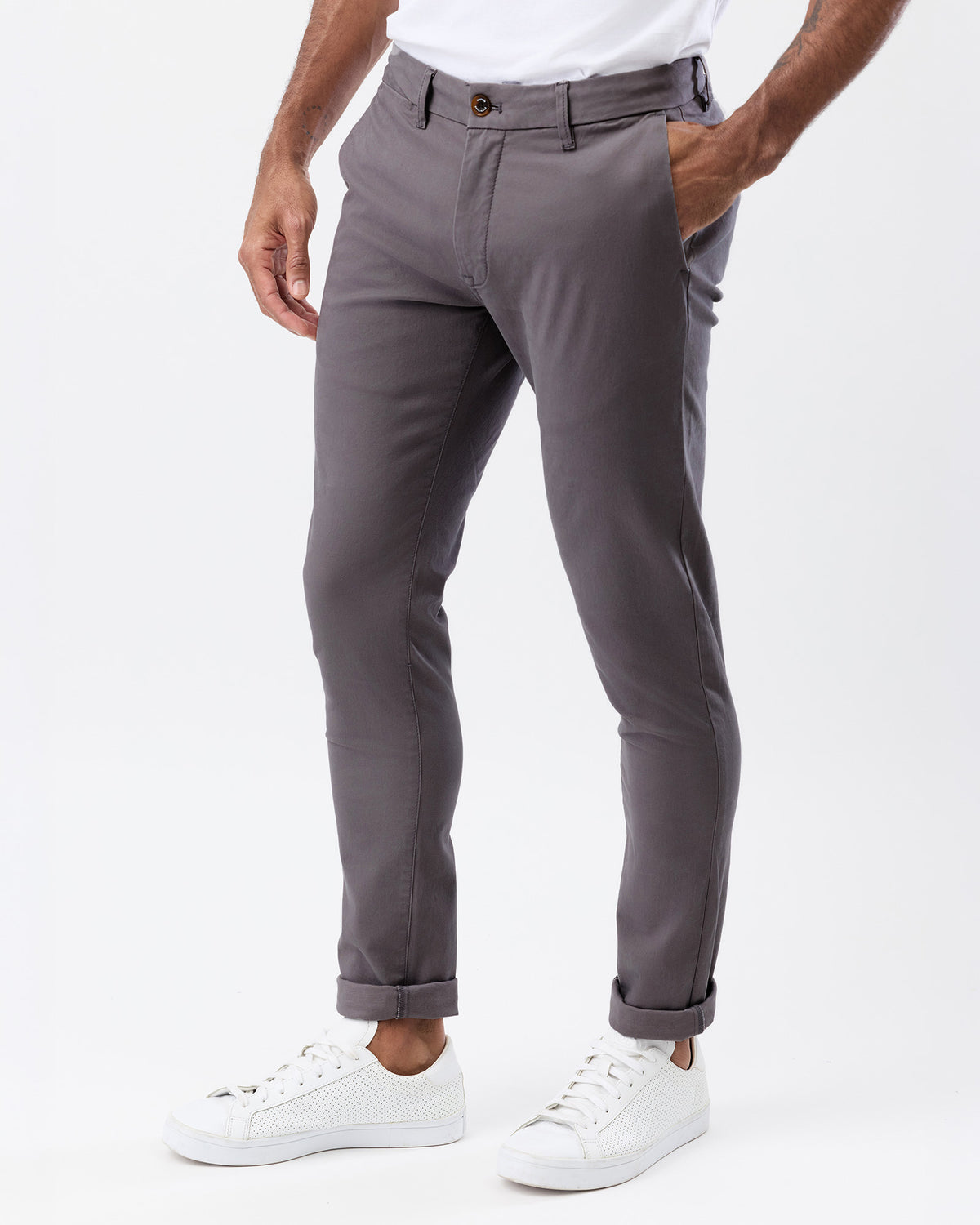 Angled view of men's smoke grey stretch chino pants showing the slim fit, side pockets and tapered leg silhouette.